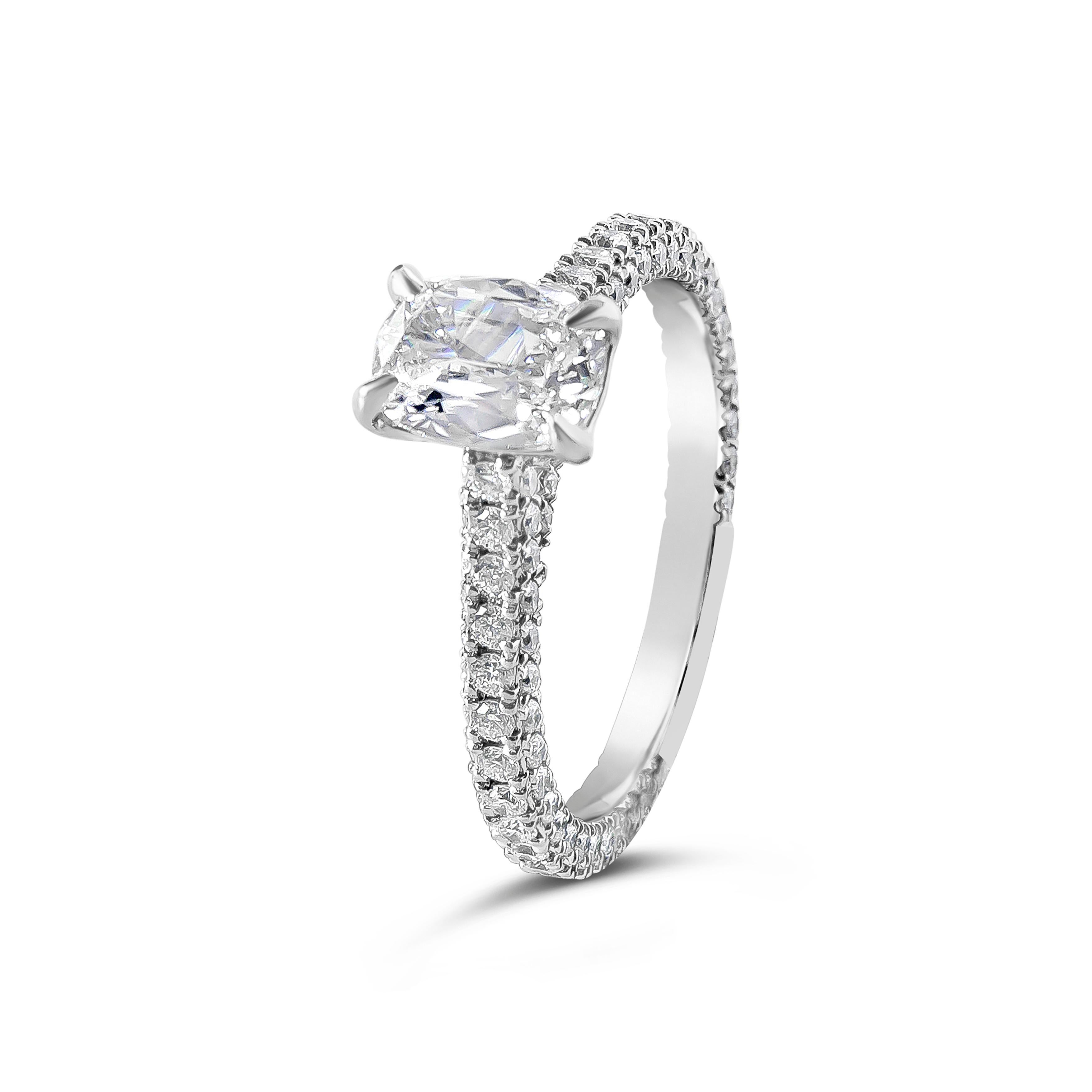 An elegant ring of elongated cushion cut diamond weighing 0.85 carat certified by GIA as I color and VS2 clarity. Set on an intricately designed platinum shank accented with micropavé round brilliant cut diamonds weighing 0.90 carat total. Size 6.75