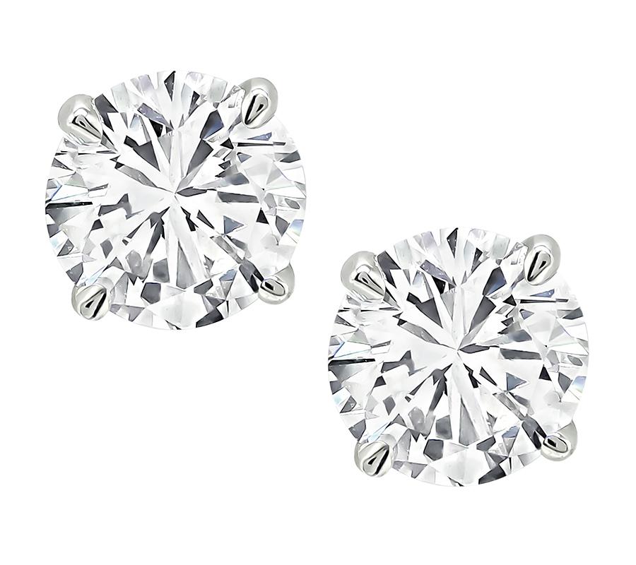 This is a charming pair of diamond 14k white gold stud earrings. The earrings are set with sparkling GIA certified round cut diamonds that weigh 0.88ct and 0.87ct. The color of the diamonds is J with VS2 clarity and I with VS2 clarity. The total