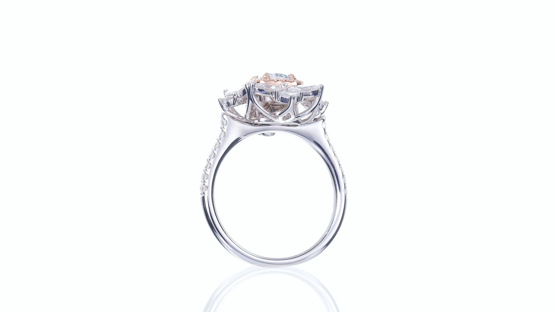This exquisite 18k white gold engagement ring is a true masterpiece, designed to capture hearts and symbolize eternal love.

 At its center lies a mesmerizing 0.88-carat Very Light Green diamond, boasting a captivating emerald cut that exudes