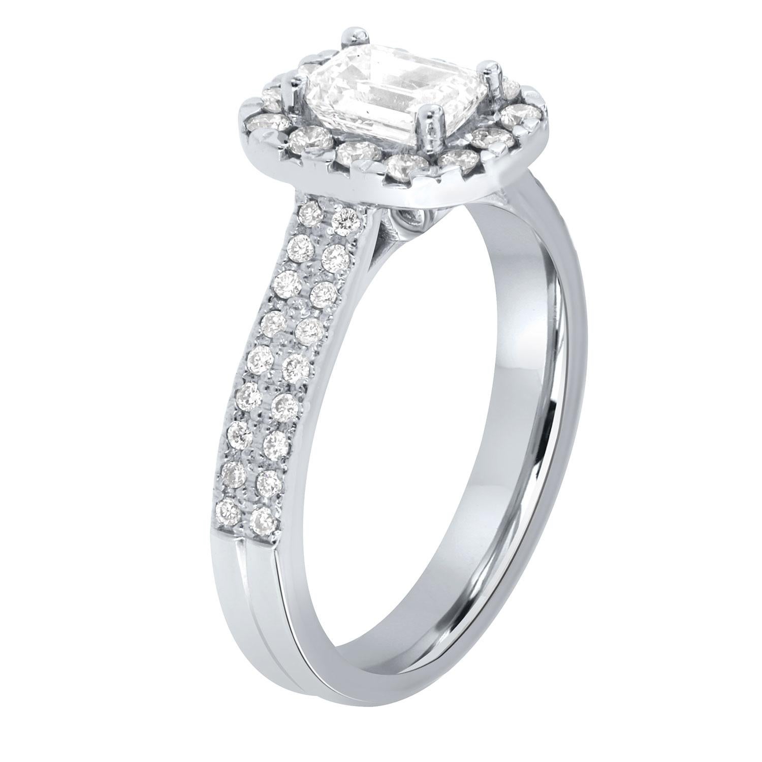 This stunning platinum setting features a 0.90 -Carat Emerald cut diamond GIA certified as an E color and vs2 in clarity. The center diamond is encircled by a Cushion-Shaped halo of brilliant round diamonds
on top of a 3.4 mm two-rows diamond band. 