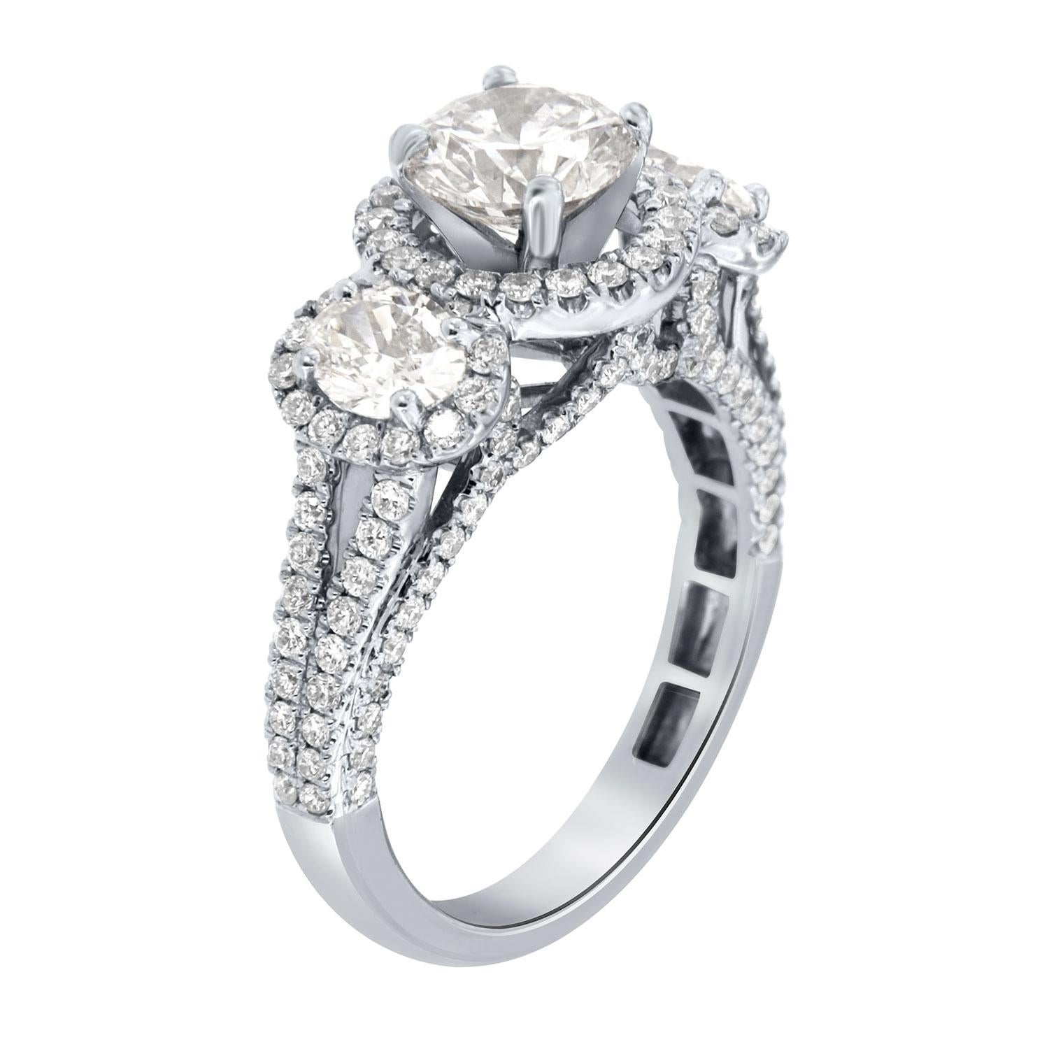 This Hand-Crafted stunning ring features 0.95- Carat F Color SI2 in Clarity encircled by a halo of delicate diamonds Micro-Prong set. It's flanked by two perfectly matched Oval-shaped diamonds surrounded by a soft halo of diamonds. Two thin rows of