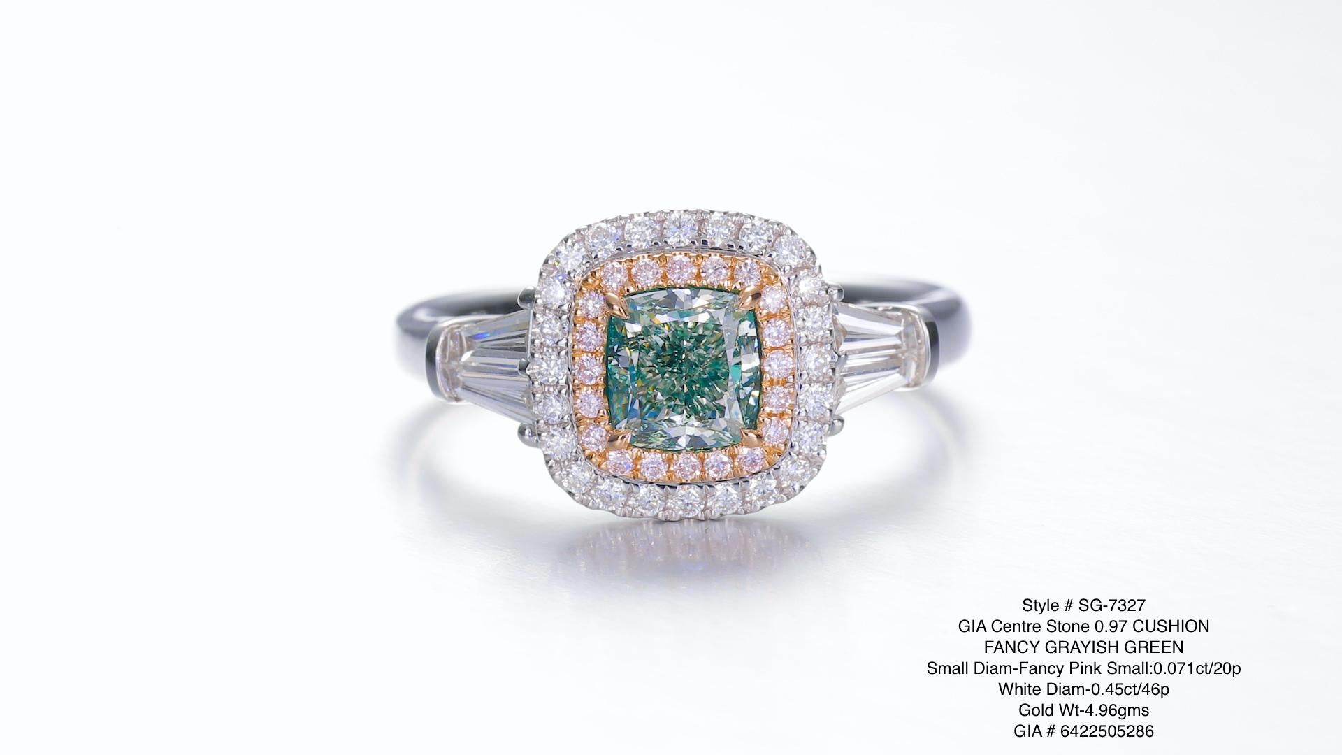 0.97ct fancy Grayish Green Cushion cut diamong studded on 18KT gold with round pink color diamonds in the halo and white diamonds on the side.

A captivating piece of artistry, this 0.97ct cushion-cut Fancy Grayish Green diamond ring is a true