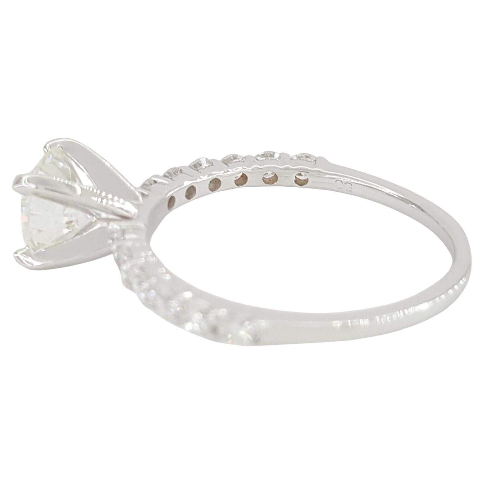 This elegant engagement ring features a stunning natural Round Brilliant Cut diamond weighing 1.00 carats. 

Certified by GIA, the diamond boasts an impressive E color grade and VVS1 clarity, offering near flawless purity and exceptional brilliance.