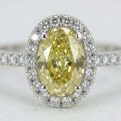 GIA Certified 1 Carat Fancy Intense Yellow Oval Diamond Halo Engagement Ring