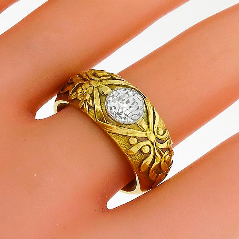 This stunning 18k yellow gold diamond ring features a sparkling old European brilliant diamond that weighs 1.00ct. graded J color with SI2 clarity. The ring is stamped with an eagle hallmark. It weighs 13.3 grams. The ring has a semi tapering width