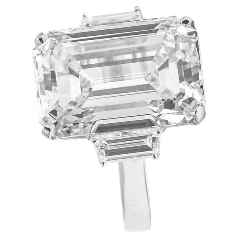 The diamond you described is set in platinum and features tapered baguette side diamonds. It is an original vintage, GIA certified diamond with an impressive size of 10 carats, showcasing a gorgeous emerald cut diamond. The diamond is 100% loop