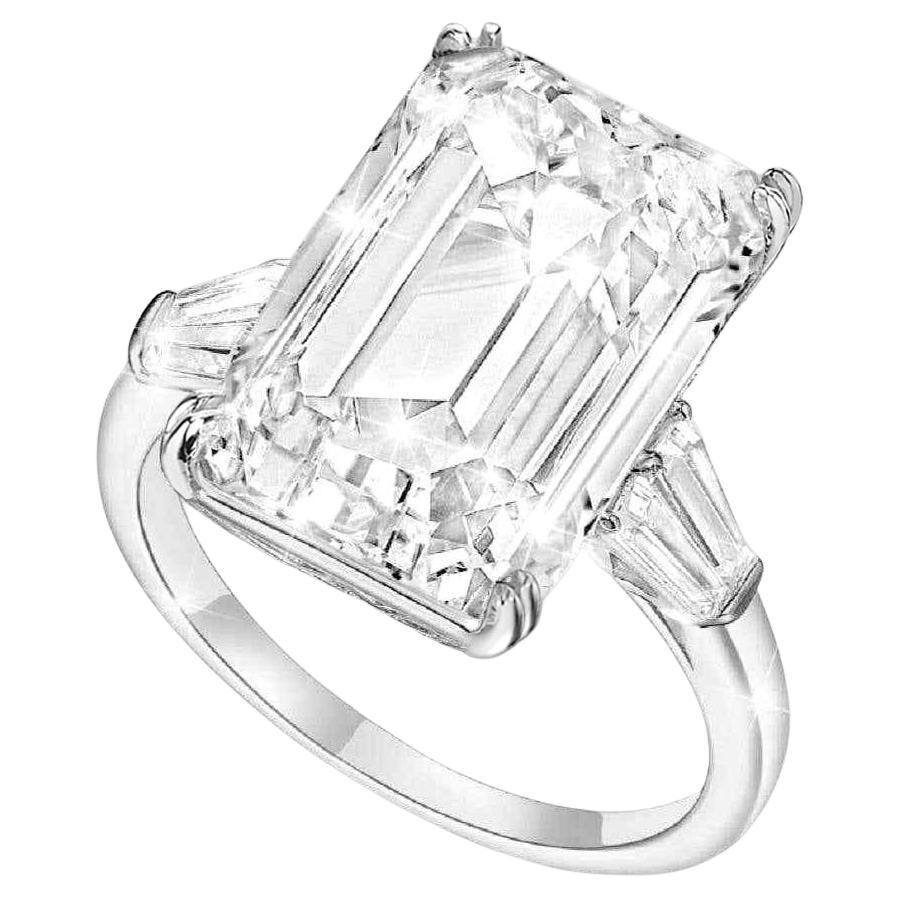 This magnificent engagement ring features a breathtaking 10 carat emerald-cut diamond, GIA certified for its remarkable quality. The elongated shape of the center stone showcases a mesmerizing hall of mirrors effect, emphasizing its depth and