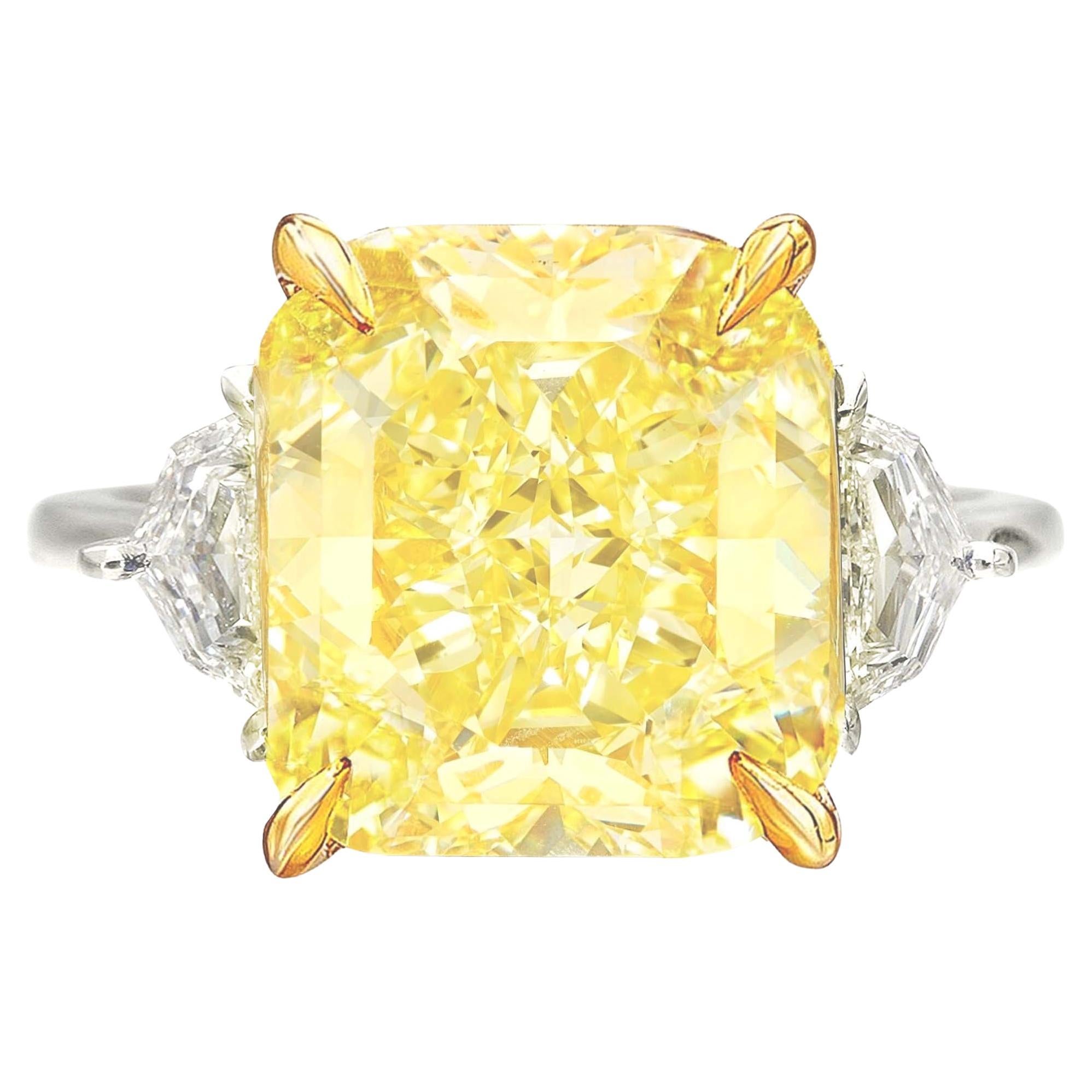 An exquisite 10 carat fancy yellow diamond ring set in platinum and 18 carats yellow gold

the ring has been handmade in Italy with two side tapered baguettes also 100% eye clean and full of brilliance!

