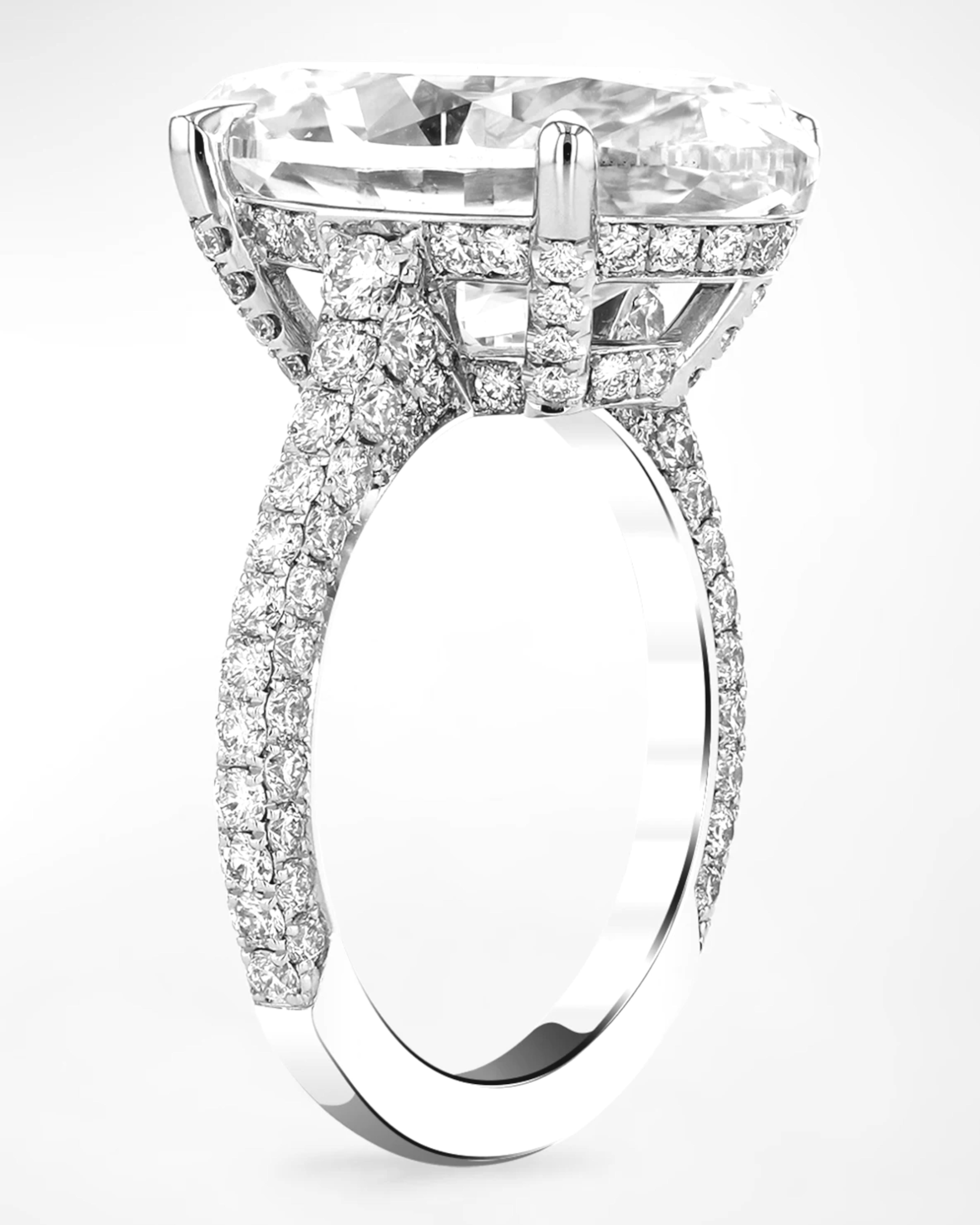 10 carat oval cut diamond set in luxurious platinum, exuding elegance and sophistication. The central diamond is GIA certified, ensuring its quality and authenticity, with a h color and vvs1 clarity that contribute to its remarkable brilliance and