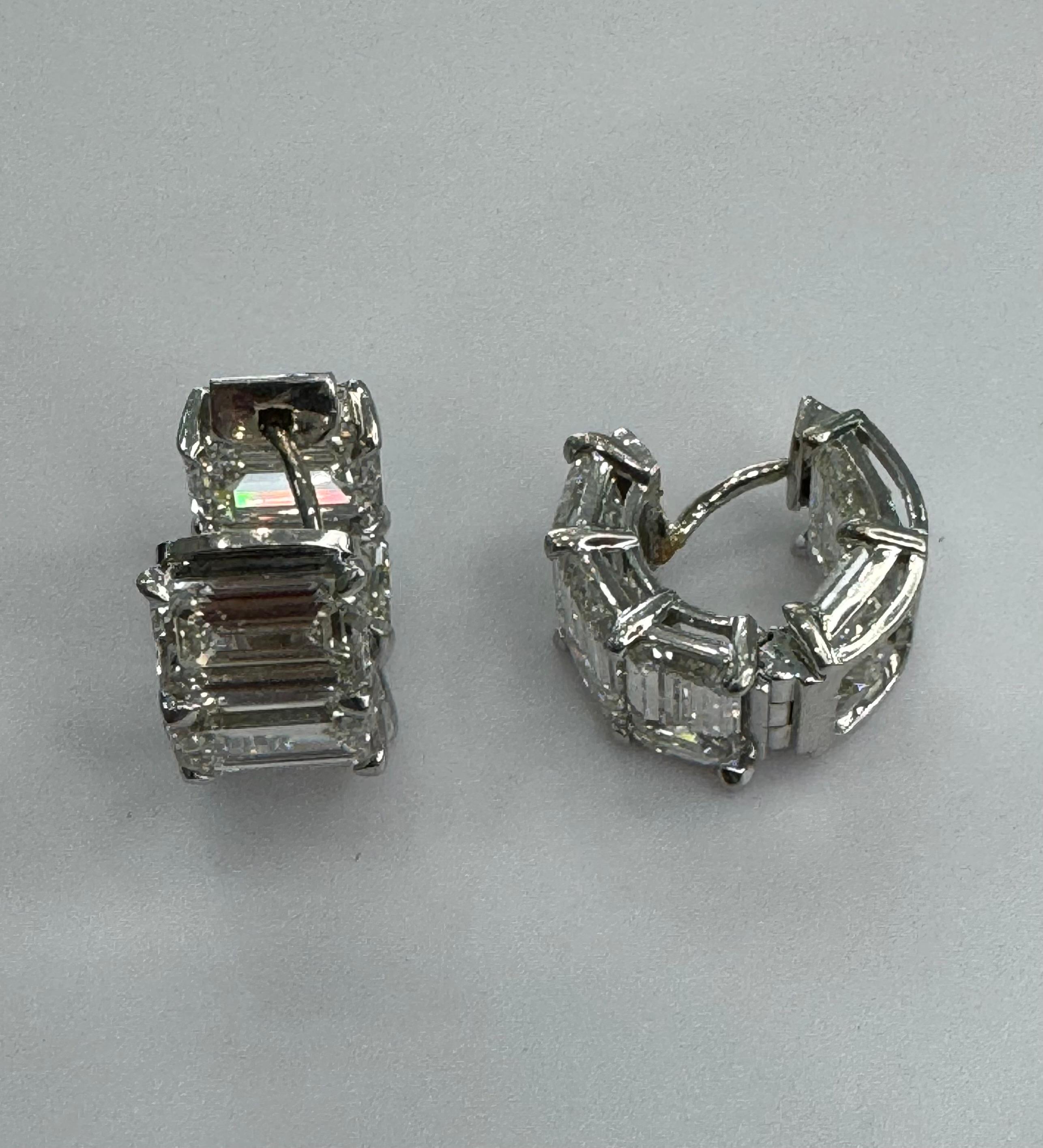GIA Certified 10 Carat Emerald Cut Diamond Huggie Earrings. Crafted in 18k White Gold, these earrings feature 10 Emerald Cut Diamonds each over 1 carat, in G/H VS-SI1 Clarity. Each stone comes with its own GIA Certificate showing its Clarity and