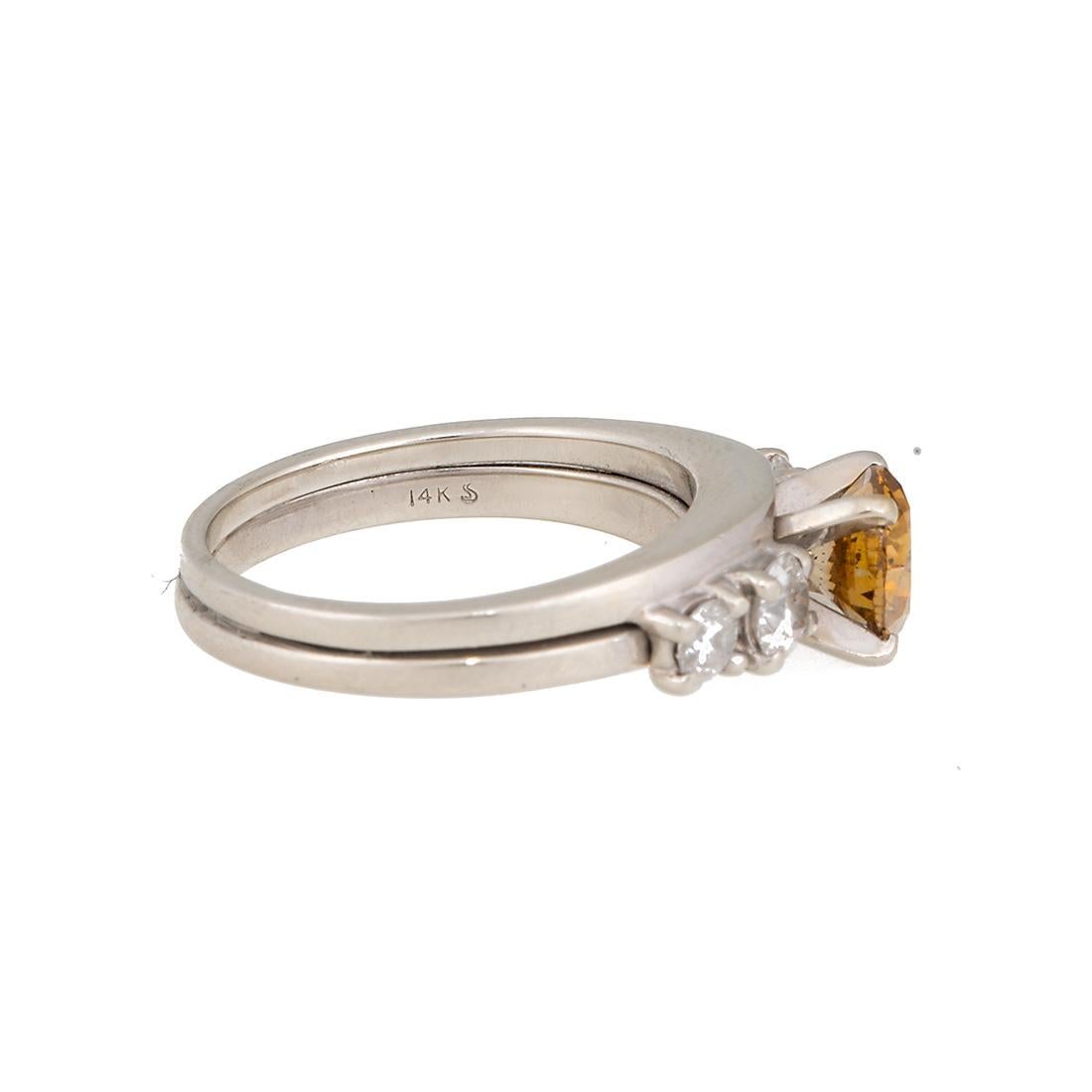 14 karat white gold ring consisting of one brilliant cut Fancy Deep Brown Yellow diamond weighing 1.00 carats  GIA # 1156121158 flanked by 4 white round diamonds weighing a total of 0.30 carats. 
Size 5.5
Every Upper-Luxury piece will arrive in an