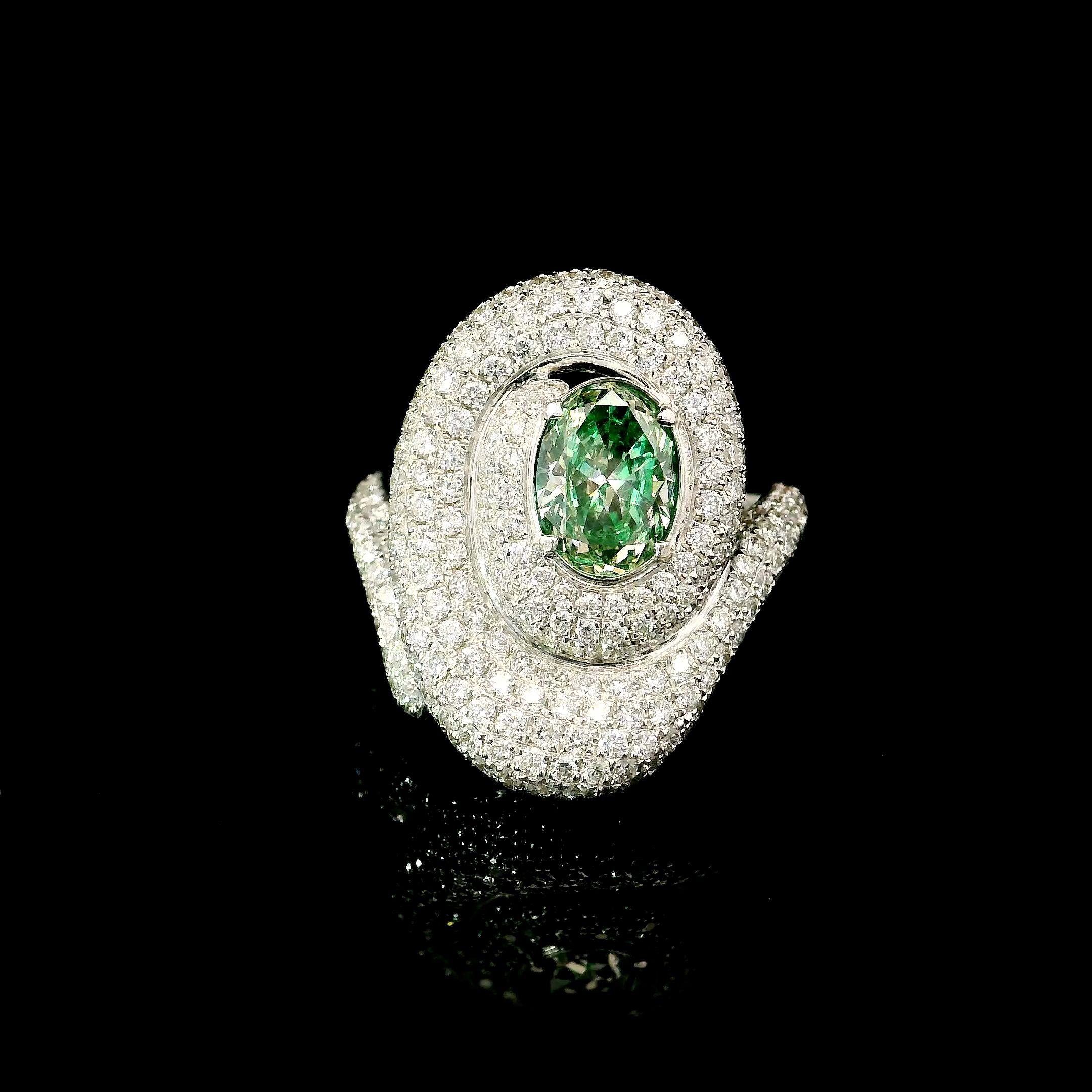 18kt white gold ring with diamonds
  
  Gold colour & karat: White gold 18kt
  Weight: 9.11 grams
  
  Set with-
  Stone type: Diamonds
  Shape: Oval
  Carat: 1.00 ct
  Colour: Fancy Intense Green
  Clarity: VVS 
  
  Surrounding Stones: Diamonds
