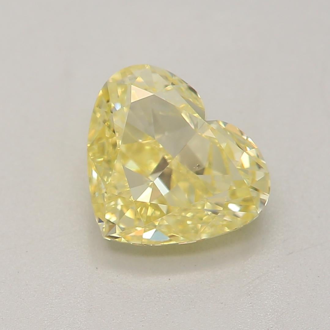 Certificate: GIA 
Report Number: 3435001427
Shape And Cut: Heart
Carat Weight: 1.00 carat
Measurements: 5.68 x 6.70 x 3.32 mm
Color Grade: Fancy Yellow

FEATURES OF THE DIAMOND:

This fancy yellow diamond is a vibrant and rare diamond known for its