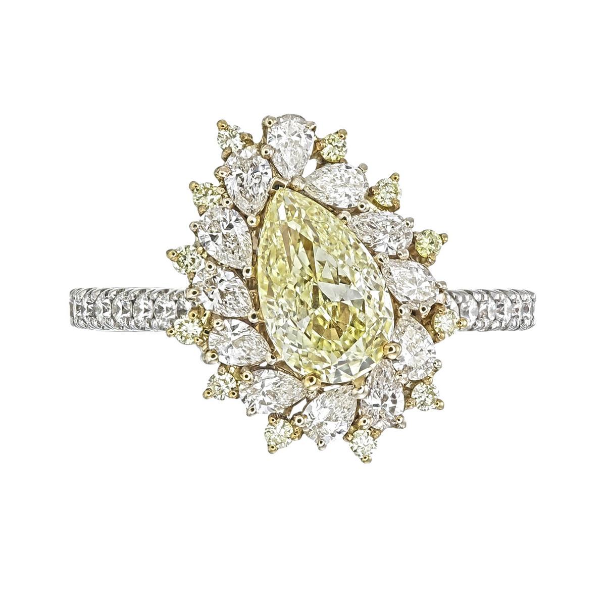 18kt white gold ring with diamonds
  
  Gold colour & karat: White gold 18kt
  Weight: 3.382 grams
  
  Set with-
  Stone type: Diamond
  Shape: Pear
  Carat: 1.00 
  Colour: Fancy Yellow  
  Clarity: VVS2
  
  Surrounding Stones: Diamonds
 1) Side