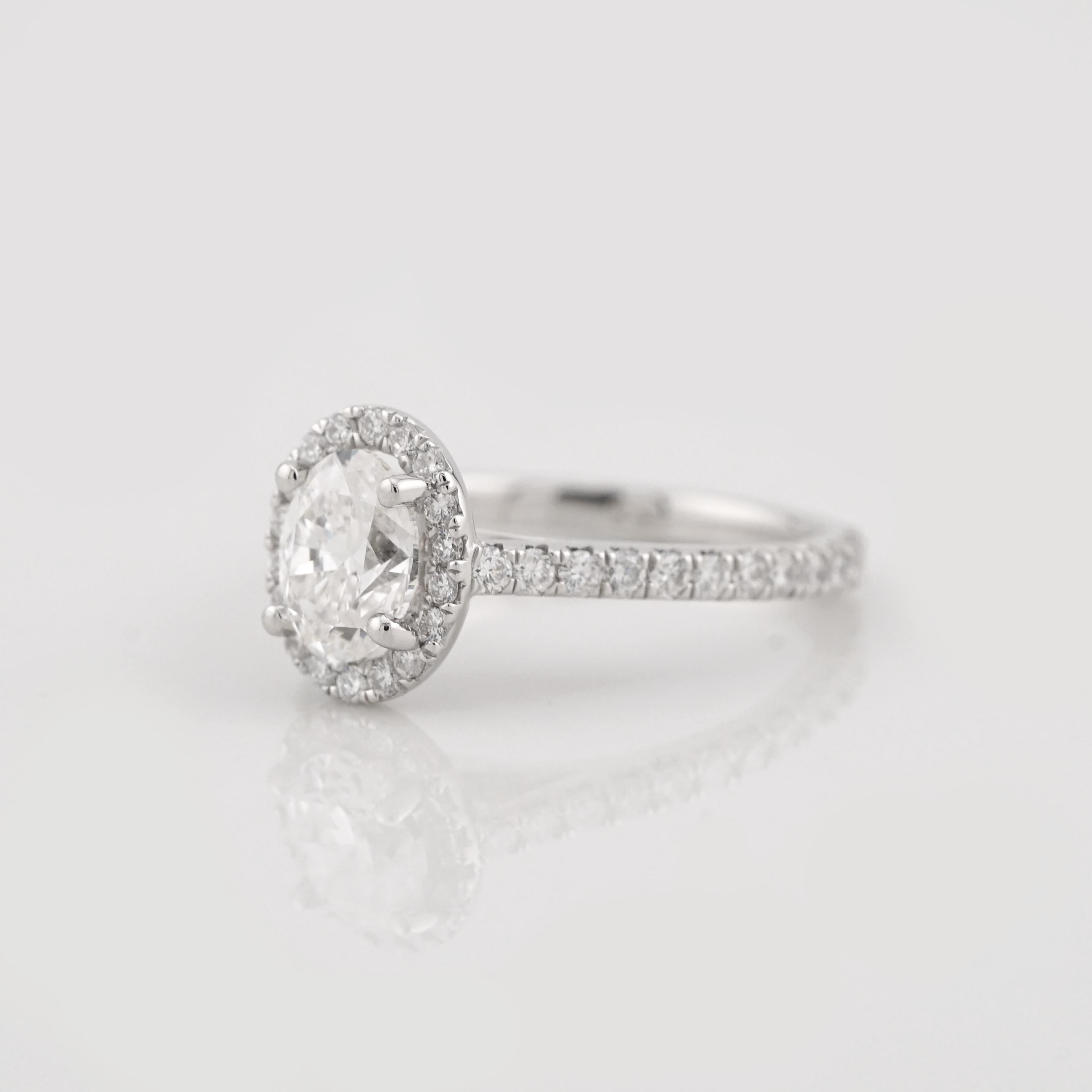Contemporary GIA Certified 1.00 Carat H VS2 Oval Diamond Halo Platinum Ring For Sale