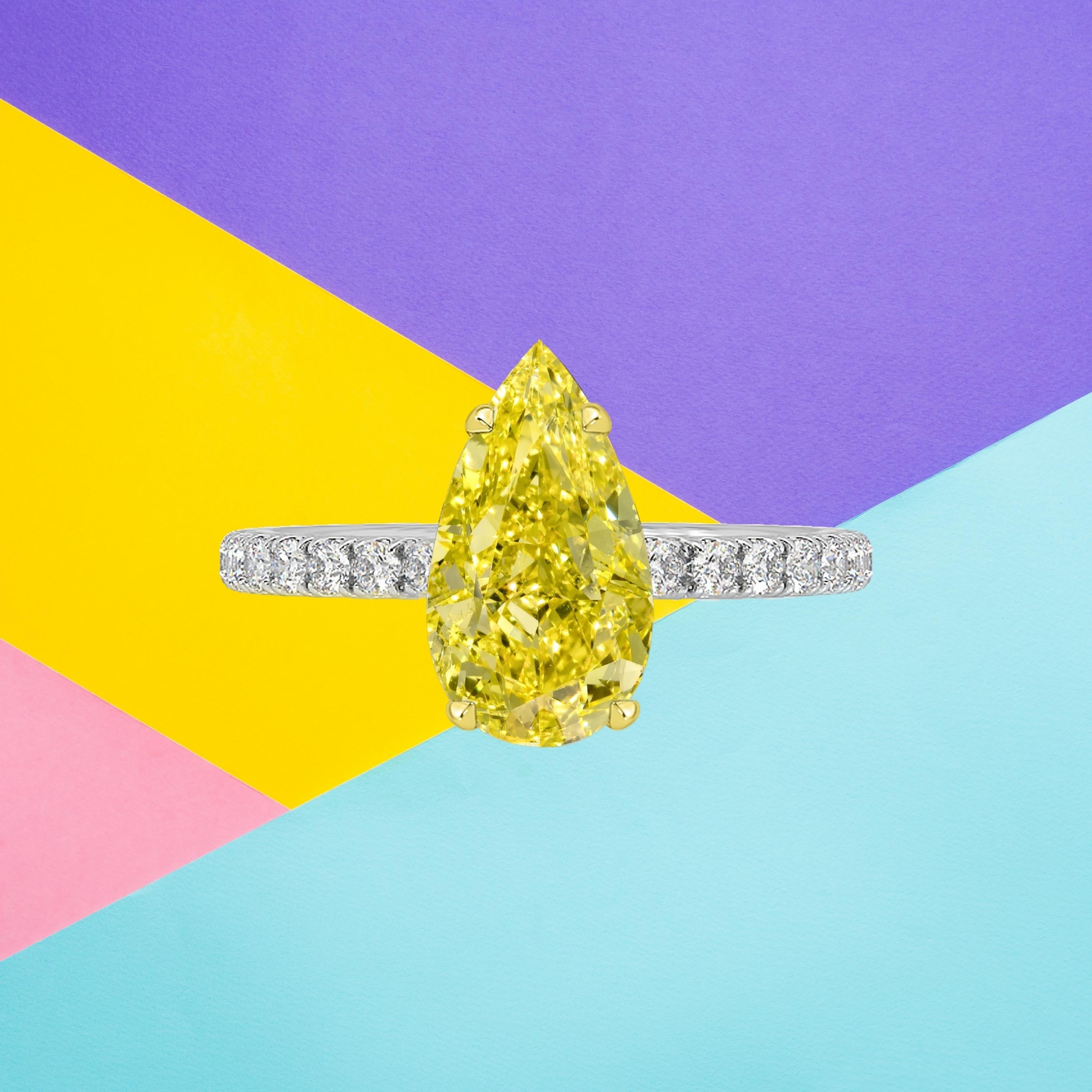 This pear shape diamond weighs 1.00 carat and is certified 'Fancy Vivid Yellow' color by the Gemmological Institute of America. The GIA has also assigned a SI2 clarity grade to the stone. The diamond has been inscribed with the certificate number to