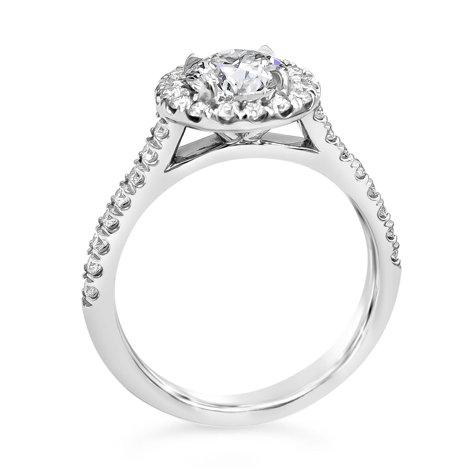 A classic and popular engagement ring style showcasing a 1.00 carat round brilliant diamond, certified by GIA as I color, SI1 clarity. Surrounding the diamond center is a single row of round brilliant diamonds, set on an accented pave mounting.