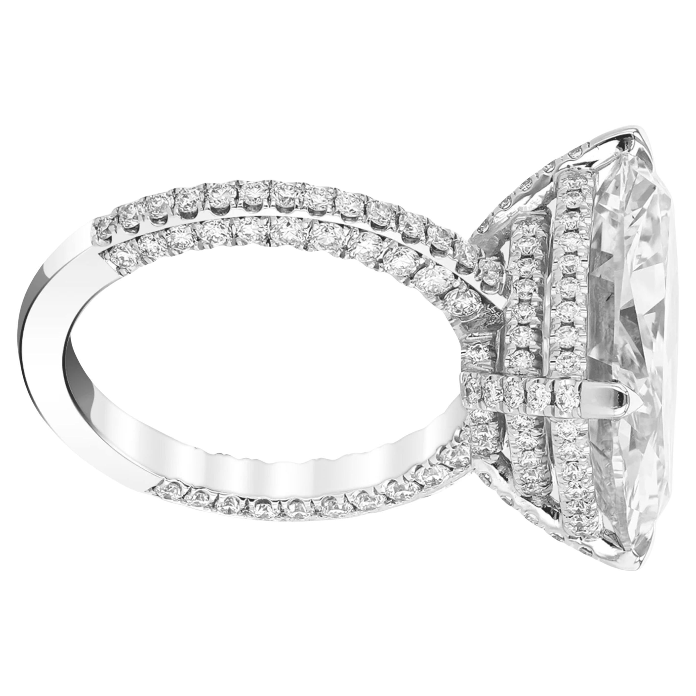 This magnificent engagement ring showcases a dazzling 10.01 carat cushion cut diamond as it's centerpiece, certified by GIA for exceptional quality. 
Crafted in 18K white gold, the design features a pavé band that adds a touch of refined sparkle.