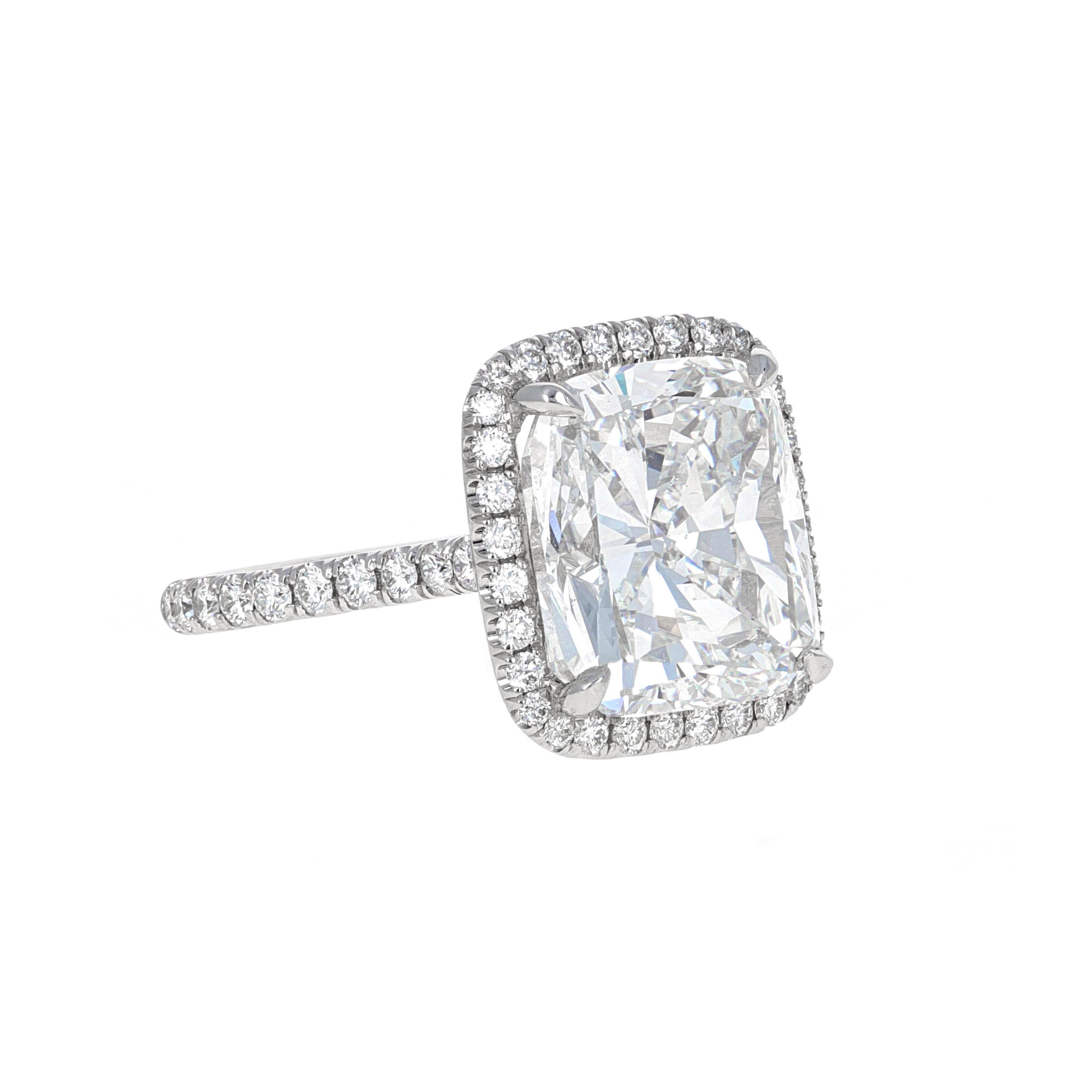 This 10.01 carat diamond cushion modified brilliant Engagement Ring is GIA certified. GIA describes the center stone as a Cushion Modified Brilliant. The stone measures 12.72 x 11.33 x 8.21 mm. The color grade is an 