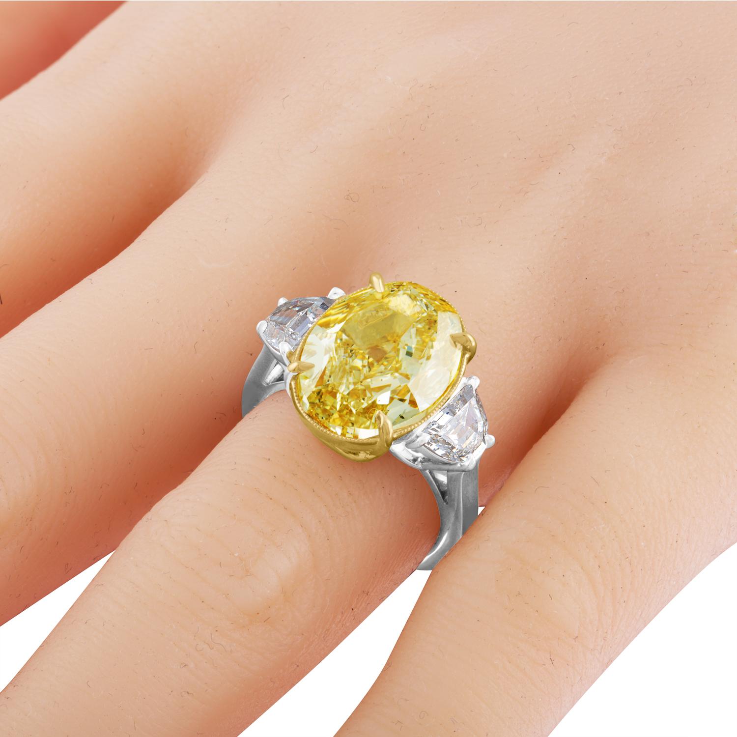 This is a very complimenting Oval Diamond Ring. A 10.01 Carat Oval Diamond, GIA Certified Fancy Brownish Yellow in Color and SI1 in Clarity. Certificate number 1142488391.
The Brilliant Diamond is set in Two Tone Mounting, the Center Diamond is set