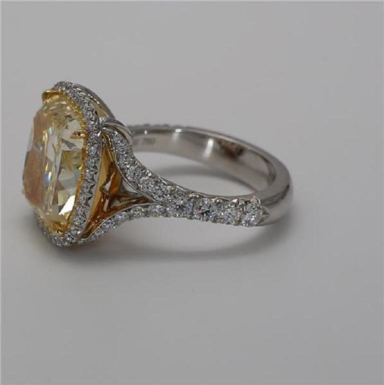 GIA Certified 10.04 Carat Fancy Yellow VS2 Clarity Cushion Cut Halo Platinum Ring accented by 1.05 carats of white round diamonds. 
Center stone set in a 18K yellow gold head. 
Ring can be sized prior to shipping.