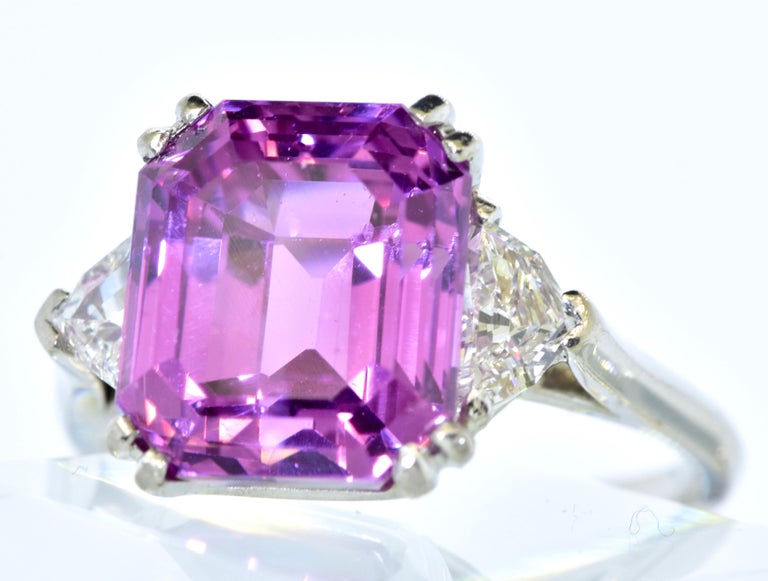 GIA certified (Gemological Institute of America) indicating that stone is a fancy color sapphire from Ceylon (Sri Lanka), purple-pink natural sapphire and weighing exactly 10.06 cts.  This emerald cut sapphire, (held with 4 double prongs), has an