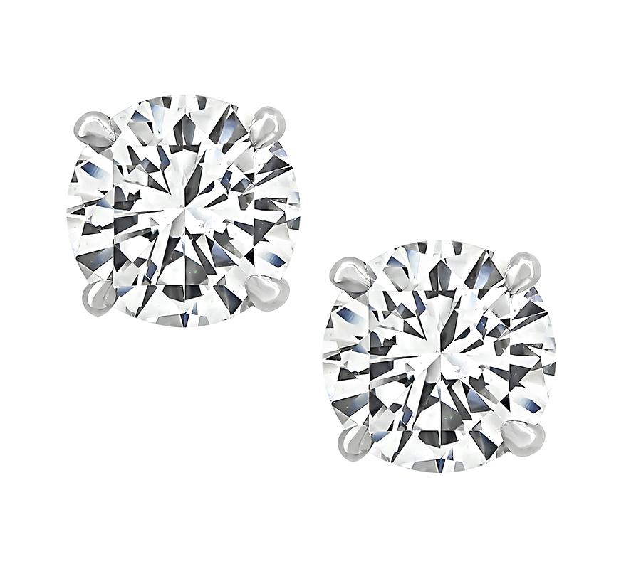 This is a fabulous pair of diamond 14k white gold stud earrings. The earrings are set with sparkling GIA certified round cut diamonds that weigh 1.00ct and 1.01ct. The color of the diamonds is E with SI1 clarity and E with VS2 clarity. The total