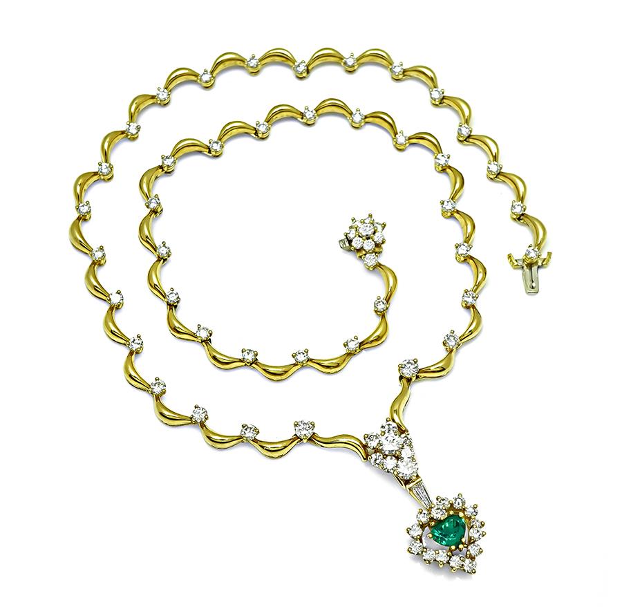 This is a gorgeous 18k yellow gold necklace. The necklace is centered with lovely GIA certified heart shape emerald that weighs approximately 1.00ct. The center stone is accentuated by sparkling round and baguette cut diamonds that weigh
