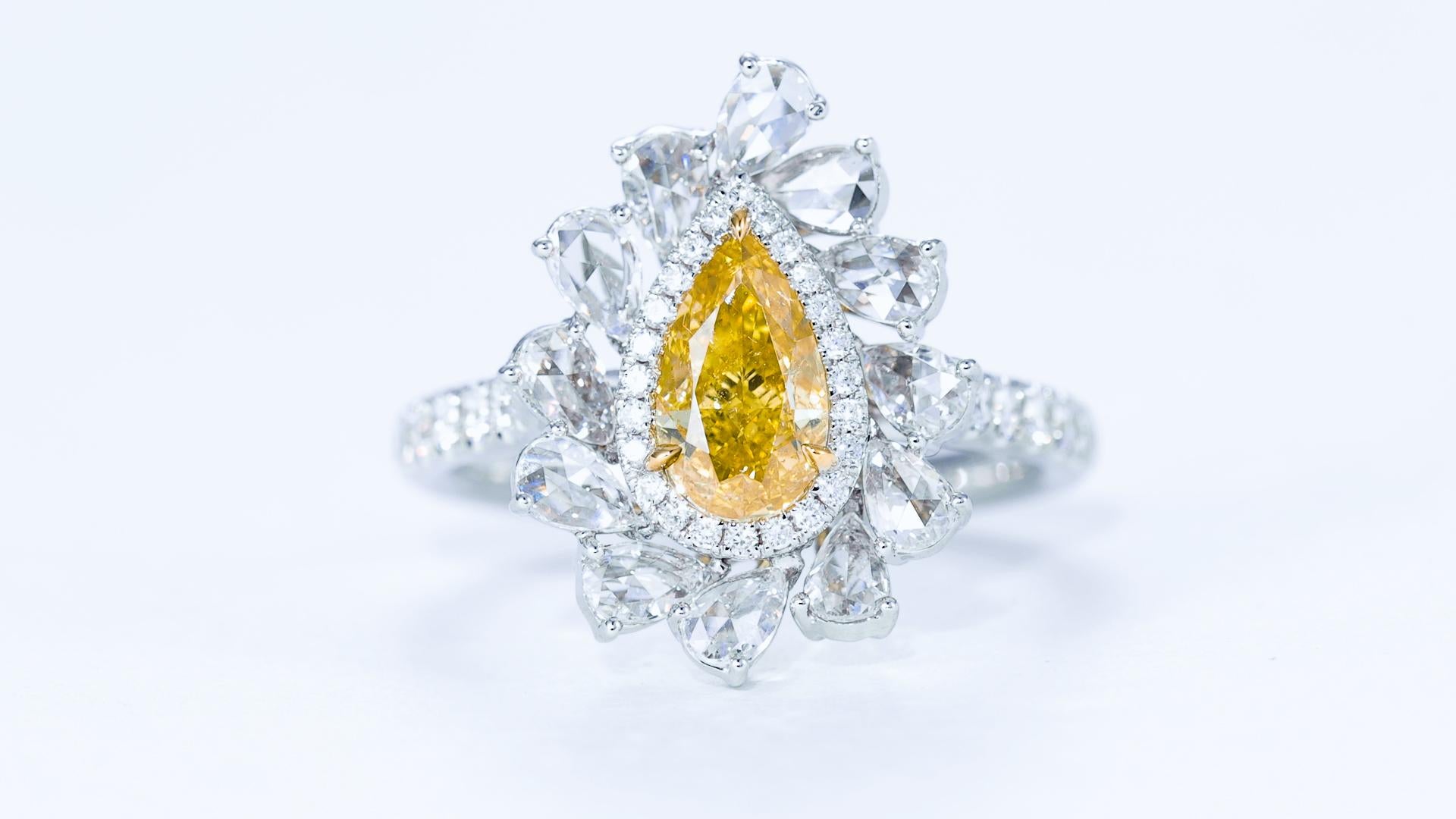 This stunning ring is a true testament to luxury and elegance, featuring a breathtaking 1.00 carat Fancy Deep Yellow natural color pear-shaped diamond as the centerpiece. Certified by GIA (Gemological Institute of America) with certificate number