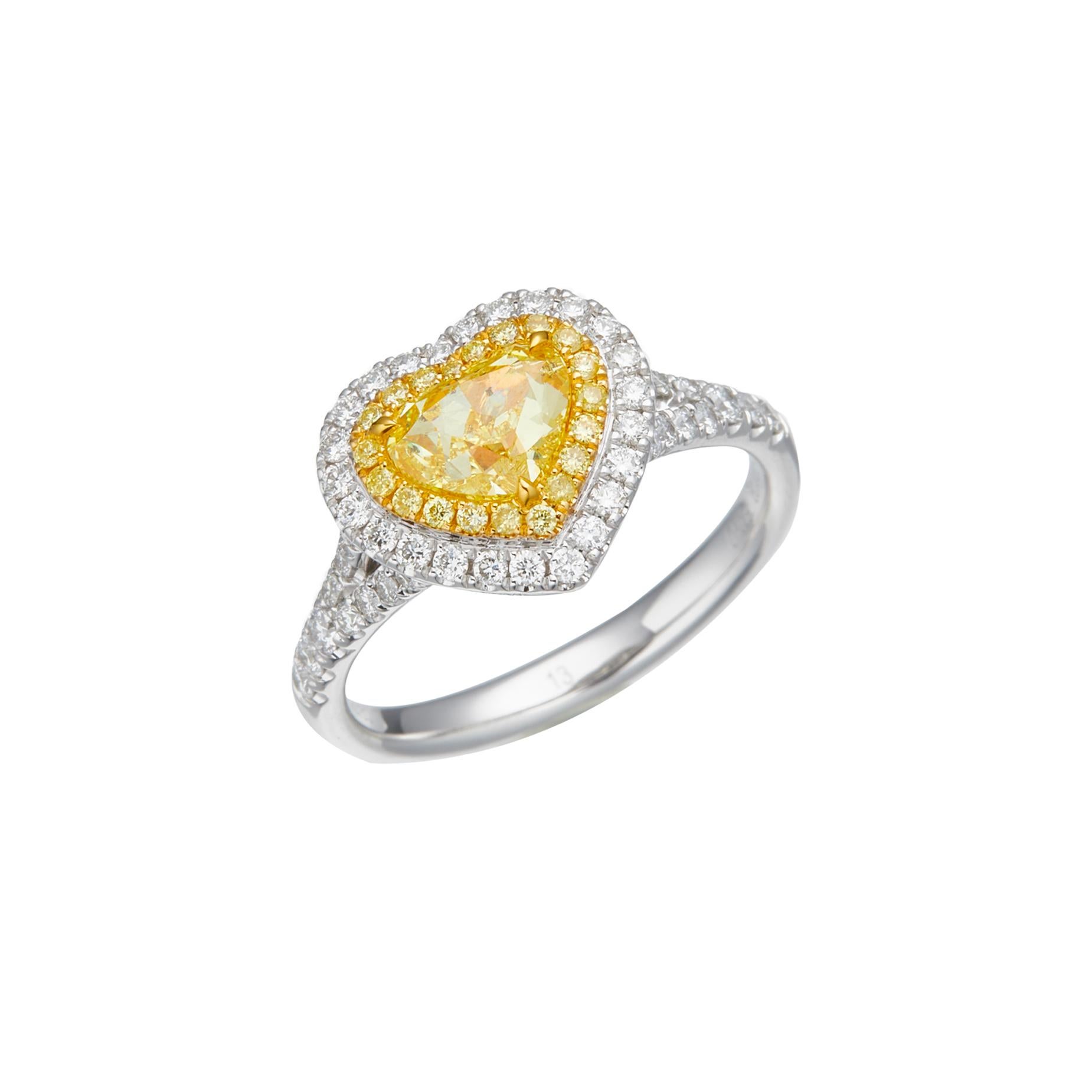 Elevate your jewelry collection with a stunning embodiment of love and beauty – a GIA Certified 1.00 carat Natural Fancy Yellow Heart Shape Solitaire Diamond Ring. Set upon a resplendent 18kt gold band, this exquisite piece captures the essence of