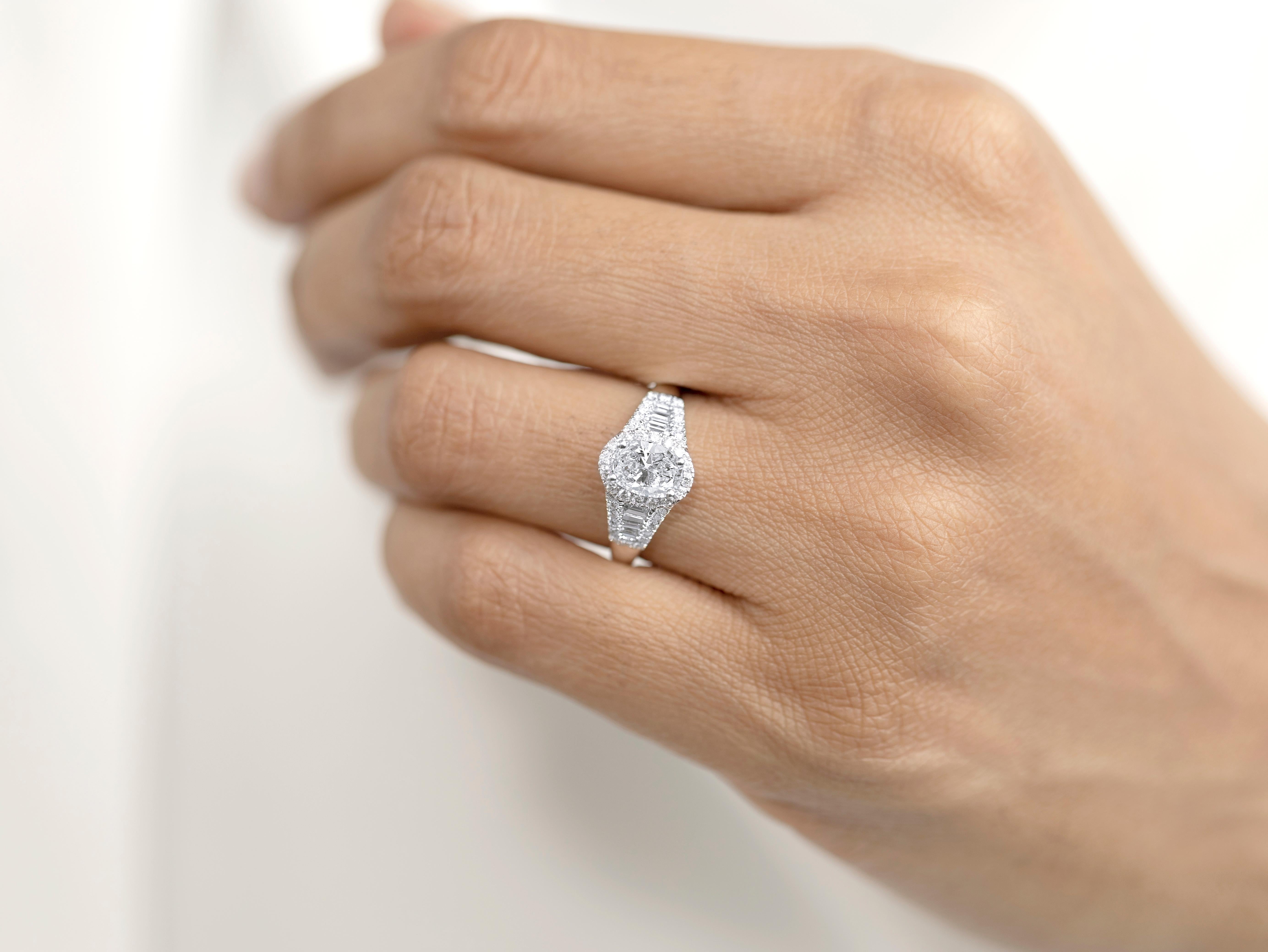 A celebration of architectural beauty and enduring elegance, this GIA-certified 1.00ct oval-cut diamond ring blends the romantic grace of vintage design with the sleek precision of modern craftsmanship. Sculpted in 18K white gold and accented by a