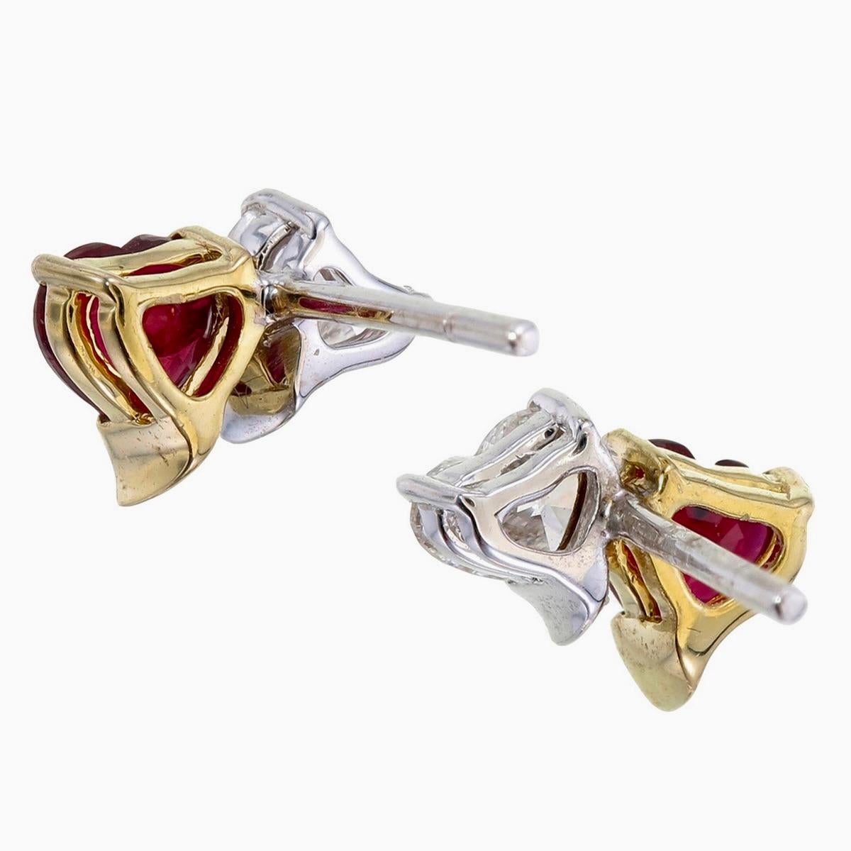 A graceful pair of minimal ruby and diamond earrings made by Rewa jewels in 18 karat white gold.

There are 2 pieces of vibrant heart shaped natural rubies weighing approximately 1.01 carat total. The rubies in these pair of earrings have been