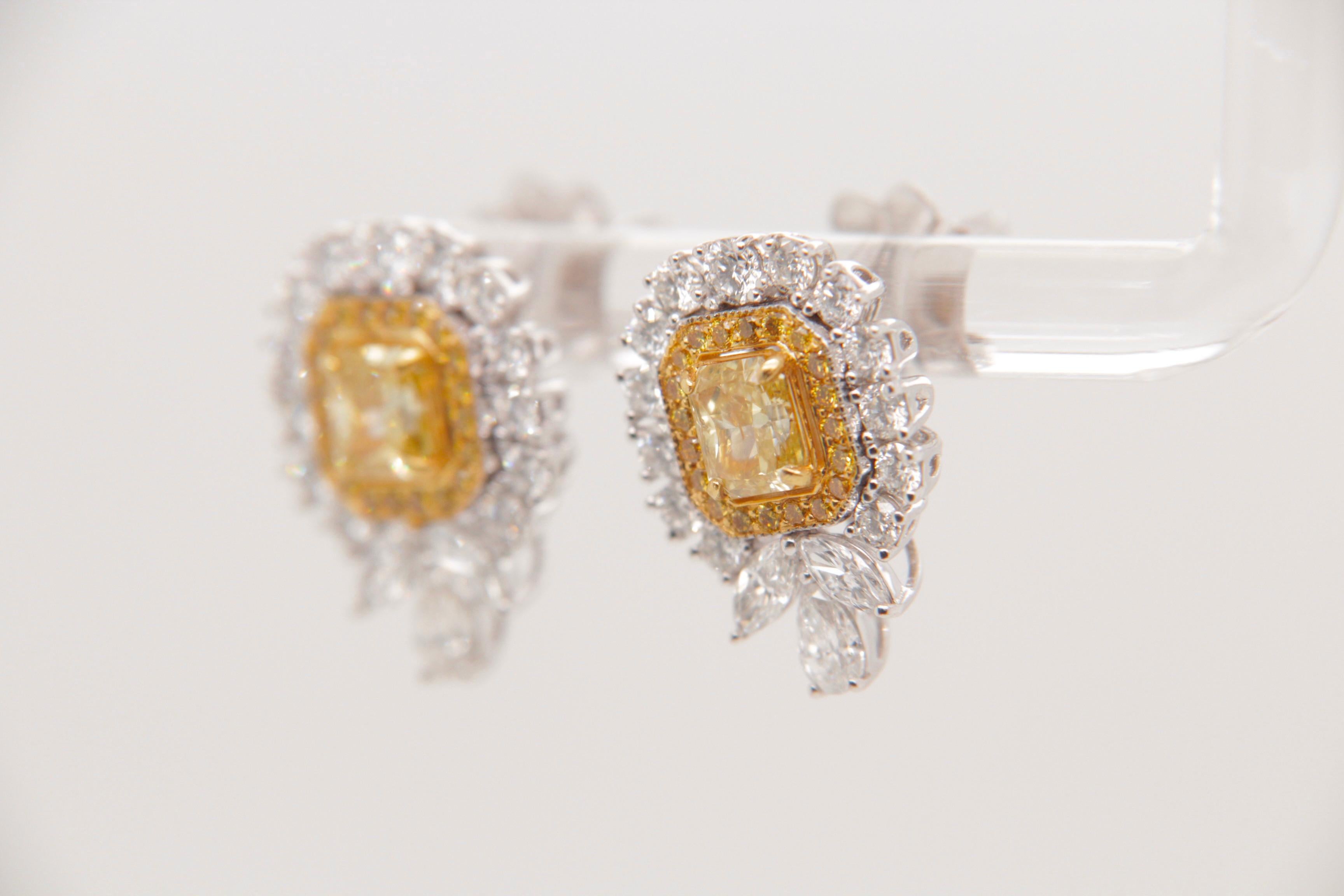 Presenting an elegant pair of earrings featuring GIA Certified Fancy Intense Yellow diamonds, weighing 0.51 and 0.50 carats each (GIA Certificate numbers: 2221323595 and 2225387208). These vibrant yellow diamonds bring a striking touch of color and