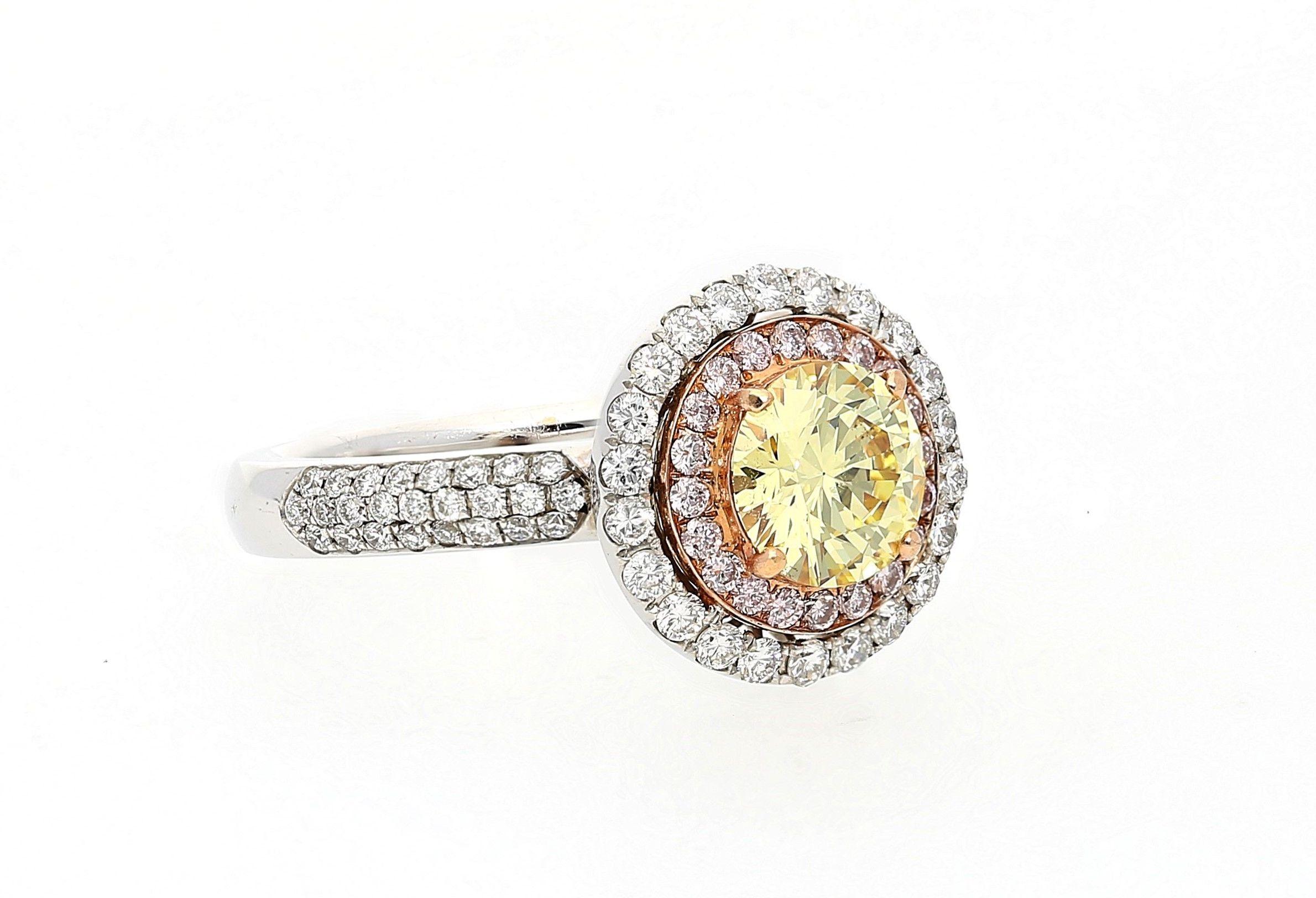 Centering a 1.01 Carat Round-Brilliant Cut Fancy Yellow Diamond of VS2 Clarity, accented by 0.68 Carats of Pink and White Round-Brilliant Cut Diamonds, and set in 18K White/Rose Gold, this gem marries three of the most prominent natural diamond