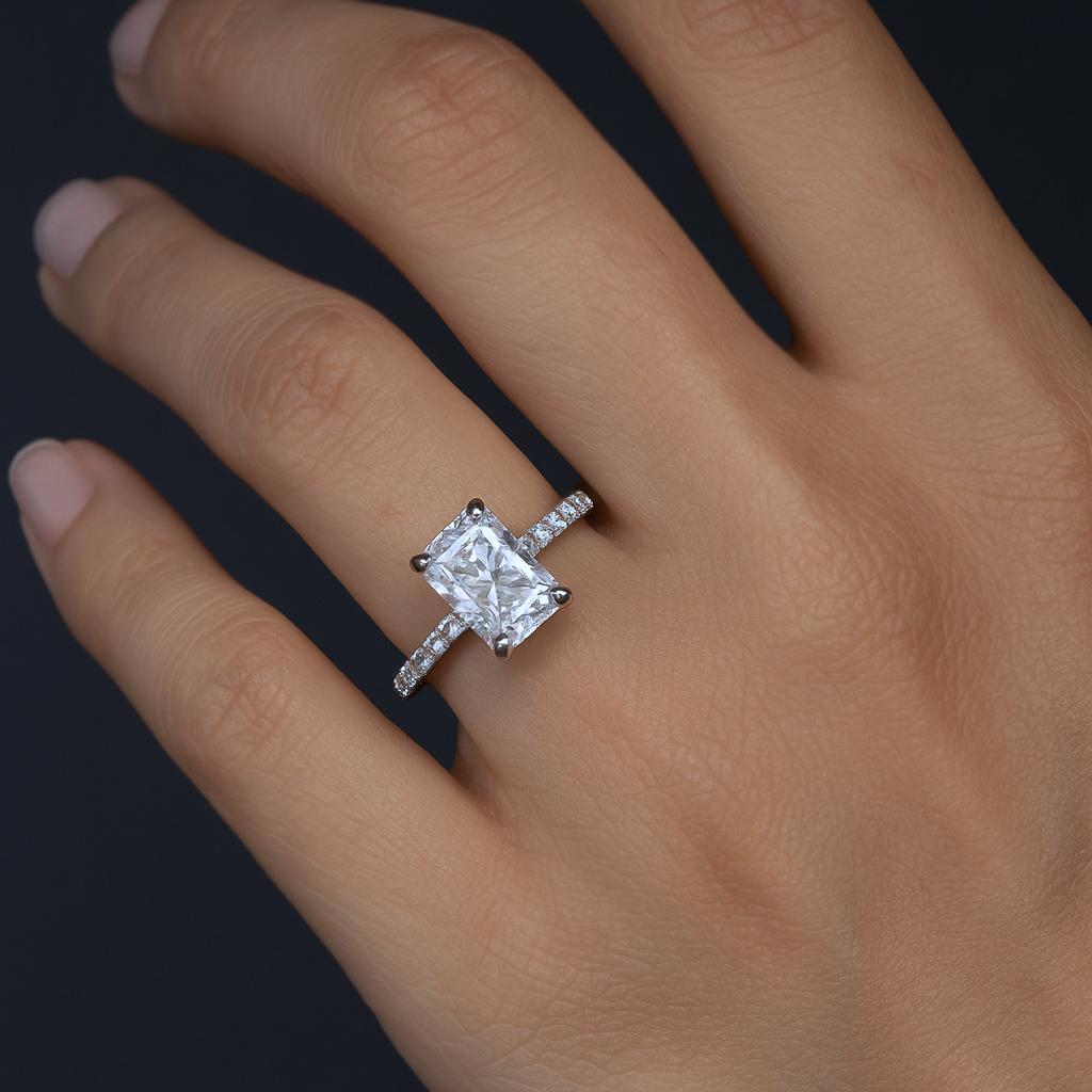 Elegant and timeless, this platinum engagement ring features a GIA certified 1.01 carat radiant cut diamond with a bright white G color and eye-clean SI1 clarity. The center stone is beautifully framed by a delicate platinum shank adorned with 0.30