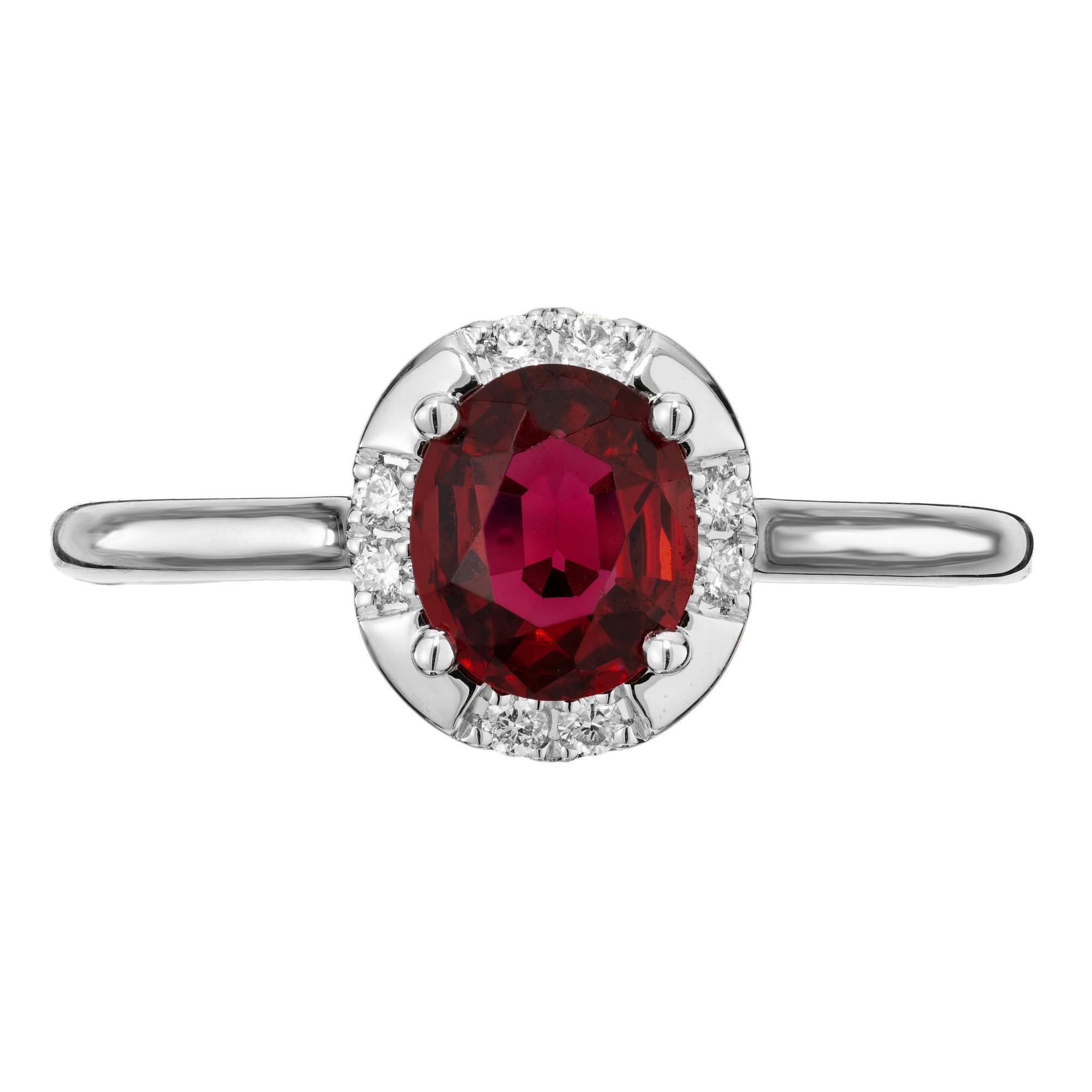 Outstanding bright red, natural no heat Burma spinel. 1.01 carat. oval center stone that is accented with a halo of 8 round brilliant cut diamonds. GIA has certified this spinel as natural with no indications of heating. The classic ring shows off