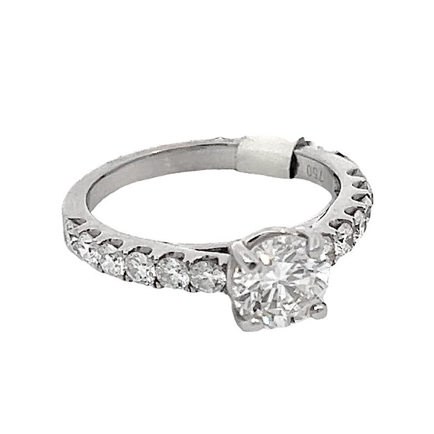18k white gold engagement ring, featuring a sparkling GIA-certified 1.01ct G-SI2 round brilliant-cut diamond. The ring is adorned with six round diamonds on each side of the center stone, this ring boasts a total of 12 diamonds along the