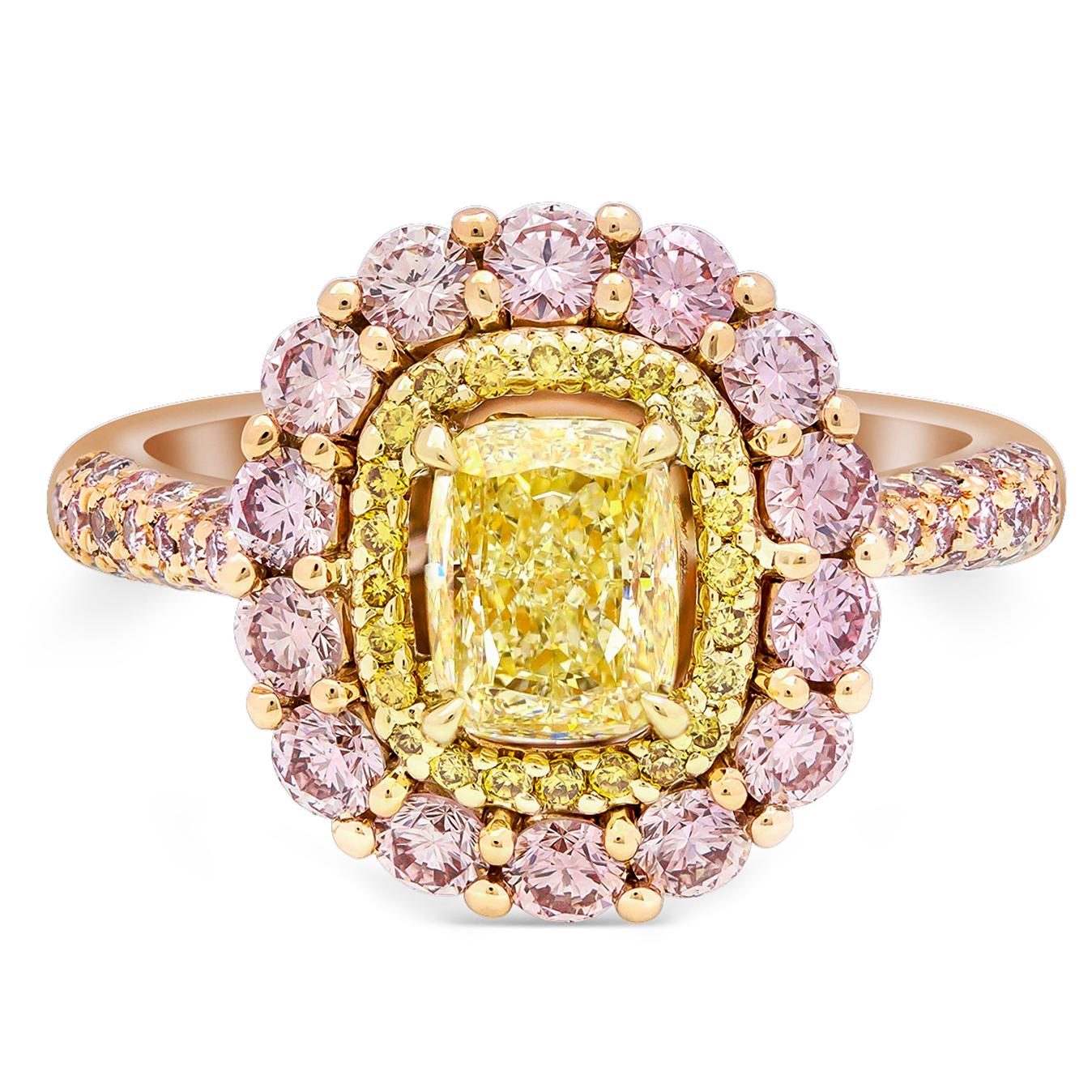 A color-rich and vibrant double halo engagement ring featuring 1.01 carats cushion cut diamond center stone that GIA certified as Fancy Yellow color and set in a yellow gold four prong basket setting. Surrounded by a double row of brilliant round