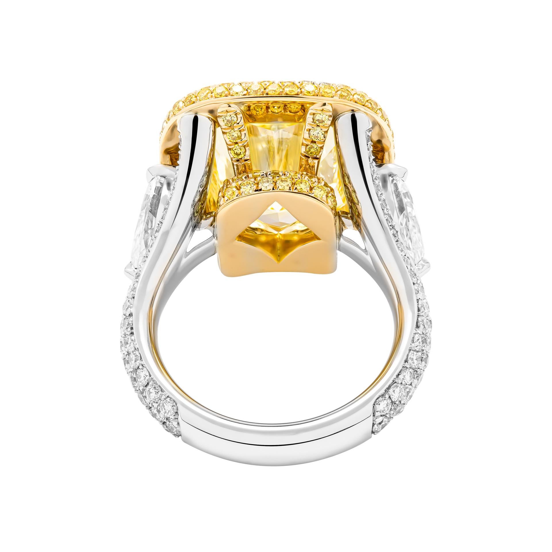 3 stone ring in 18K Yellow Gold & Platinum 
Center stone: 10.11ct Fancy Yellow VS2 Cushion Shape Diamond GIA#2215485866
 Side stones: 0.70ct F VVS2 Pear Shape Diamond GIA#3425192725 
                      0.70ct F VS1 Pear Shape Diamond