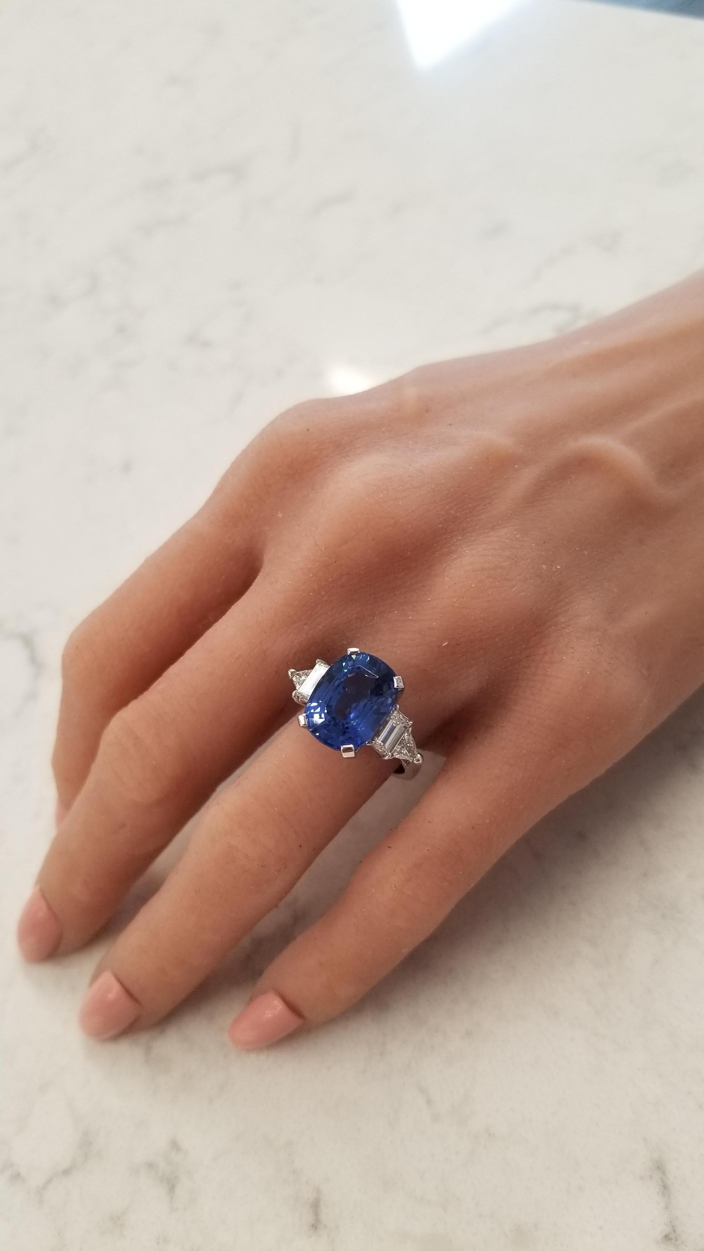 This art deco inspired ring features a GIA certified natural 10.20 carat cushion cut vibrant Ceylon royal blue sapphire prong set in the center measuring 13.70 x 10.400mm. The gem source is Sri Lanka; it's size, transparency, and luster are super.