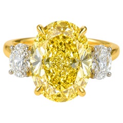 GIA Certified 10.14 Carat Fancy Yellow Oval Diamond Three-Stone Ring