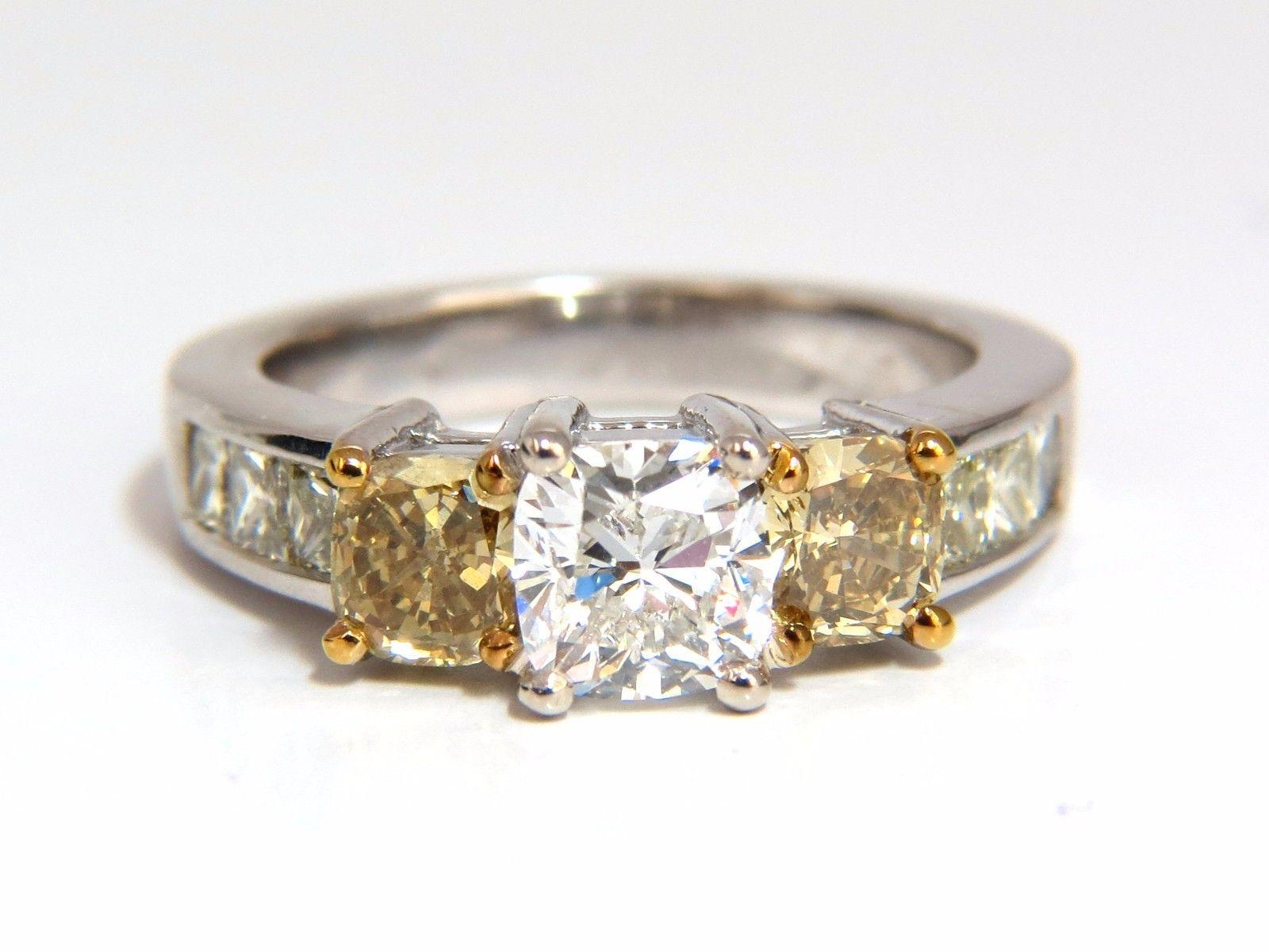 GIA 1.01ct cushion cut diamond ring.

G-color

vvs-2 clarity

Report Id: 2145774100

Please see attached photo for report. 

1.01ct. side cushion , full cut diamonds.

Fancy yellow orange browns

Vs-2 clarity.

Additional side princess cut
