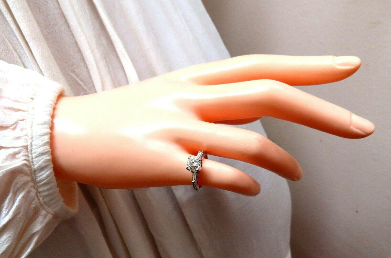 Classic Three Engagement ring

1.01ct. Natural Center Round Brilliant diamond.

Round Full Cut Brilliant

L-color Vs-1 clarity 

6.29 x 6.39 x 4.02mm

GIA Report # 2185225327

 

 .36ct (2) Side baguette diamonds.

H-color Vs-2