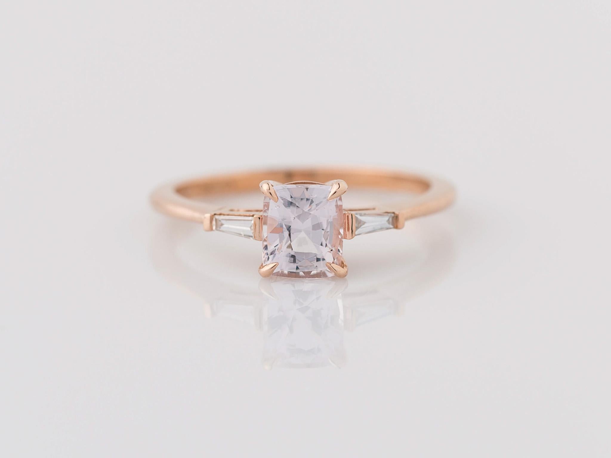 Step into a world of timeless elegance with our breathtaking GIA-certified natural 1.01 carat Light Pink Peach Sapphire 3-Stone Ring. The enchanting center stone, measuring 5.88x5.05x3.77mm, radiates natural allure with its unheated, transparent