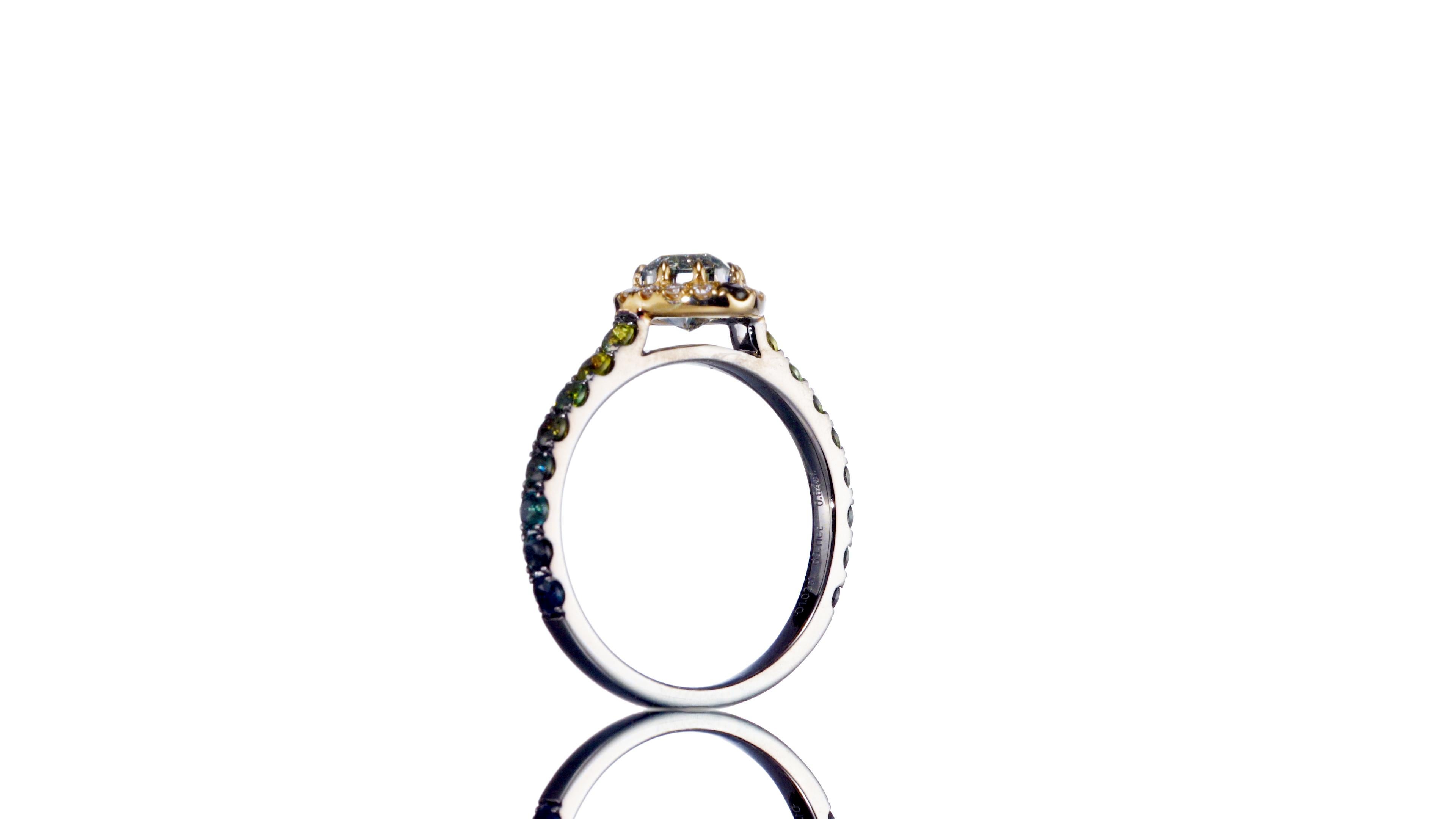 Step into the realm of rare beauty with this GIA Certified 1.02 carat Natural Fancy Gray-Green Cushion Shape Diamond Ring, a masterpiece designed to enchant and captivate. The distinctive hue of the center diamond, with its gray-green allure, adds