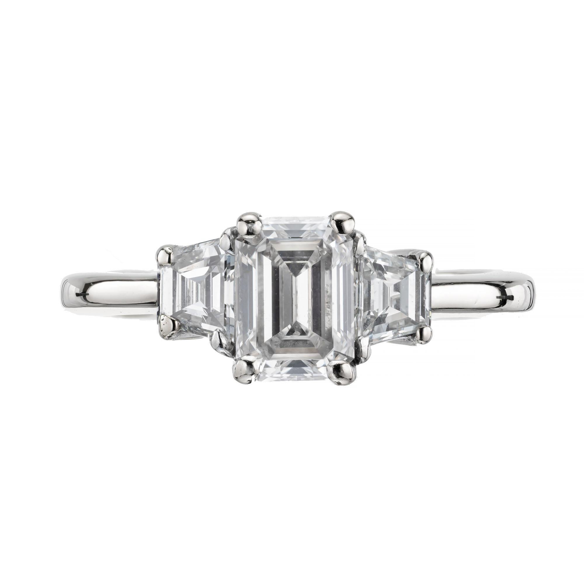 1.02 carat emerald cut diamond three-stone engagement ring. GIA certified emerald trapezoid cut center stone with 2 trapezoid side diamonds in a 18k white gold setting. 

1 emerald trapezoid cut diamond J VS2, approx. 1.02cts GIA Certificate #