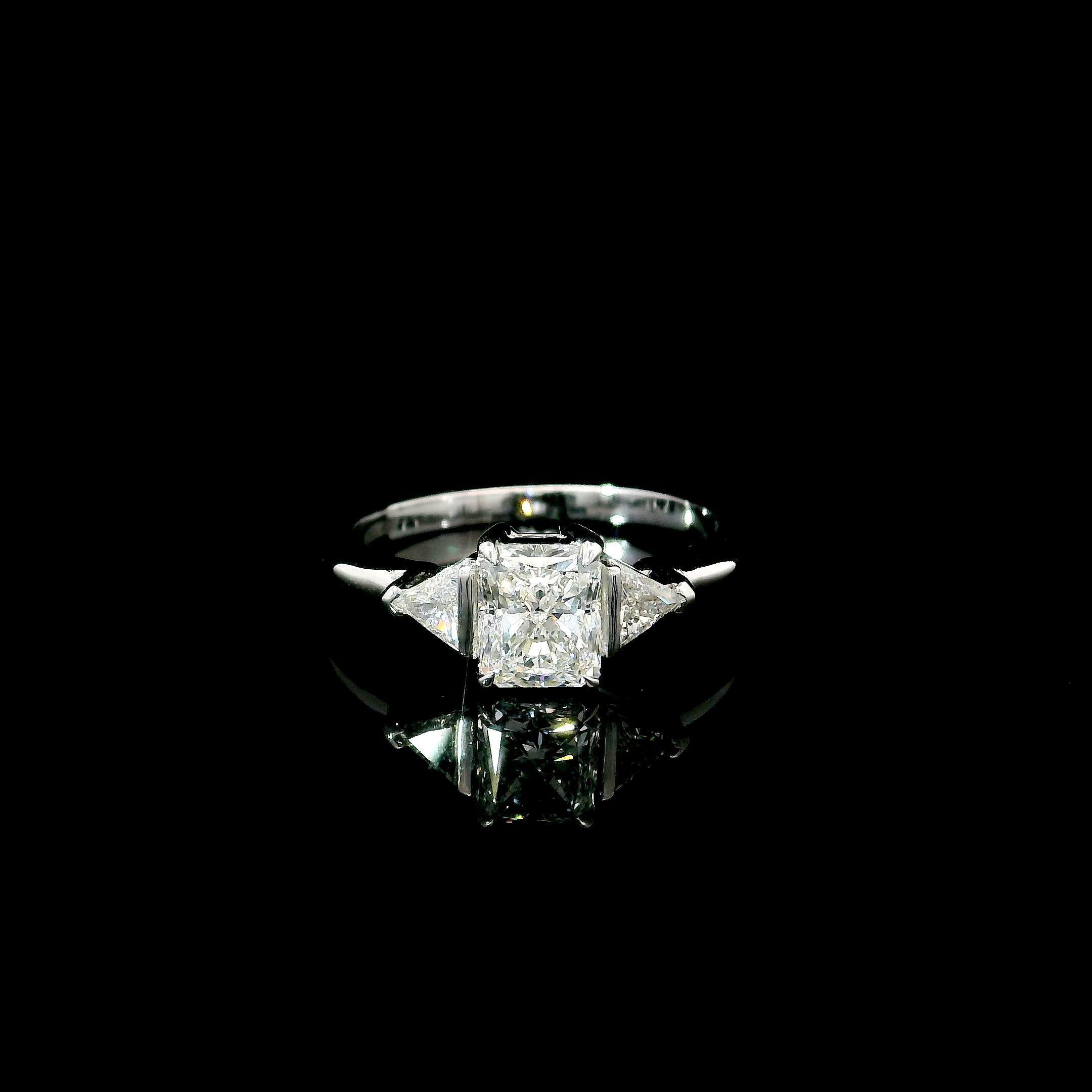 18kt white gold ring with diamonds
  
  Gold colour & karat: White gold 18kt
  Weight: 2.99 grams
  
  Set with-
  Stone type: Diamonds
  Shape: Radiant
  Carat: 1.02 ct
  Colour: E
  Clarity: IF
  
  Surrounding Stones: Diamonds
 1) Side White