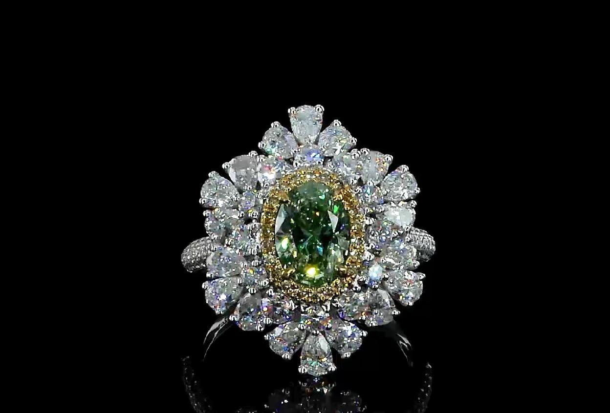 18kt white gold ring with diamonds
  
  Gold colour & karat: White gold 18kt
  Weight: 5.24 grams
  
  Set with-
  Stone type: Diamonds
  Shape: Oval
  Carat: 1.02 ct
  Colour: Fancy Greenish Yellow
  Clarity: SI1
  
  Surrounding Stones: Diamonds
