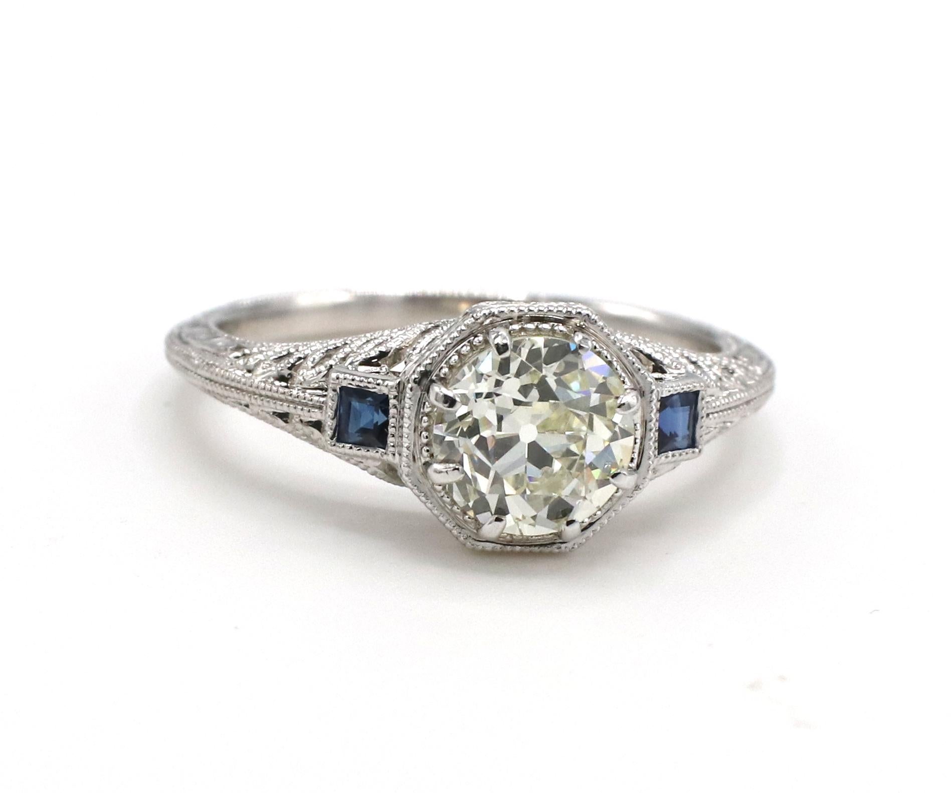 GIA Certified 1.02 Carat L VSI Old European Cut Art Deco Style Engagement Ring With Sapphires 
GIA Report number: 2225274431
Diamond: 1.02 carat Old European cut L VS1 natural diamond
Sapphires: 2 square cut blue sapphires, approx. .10 CTW
Metal: