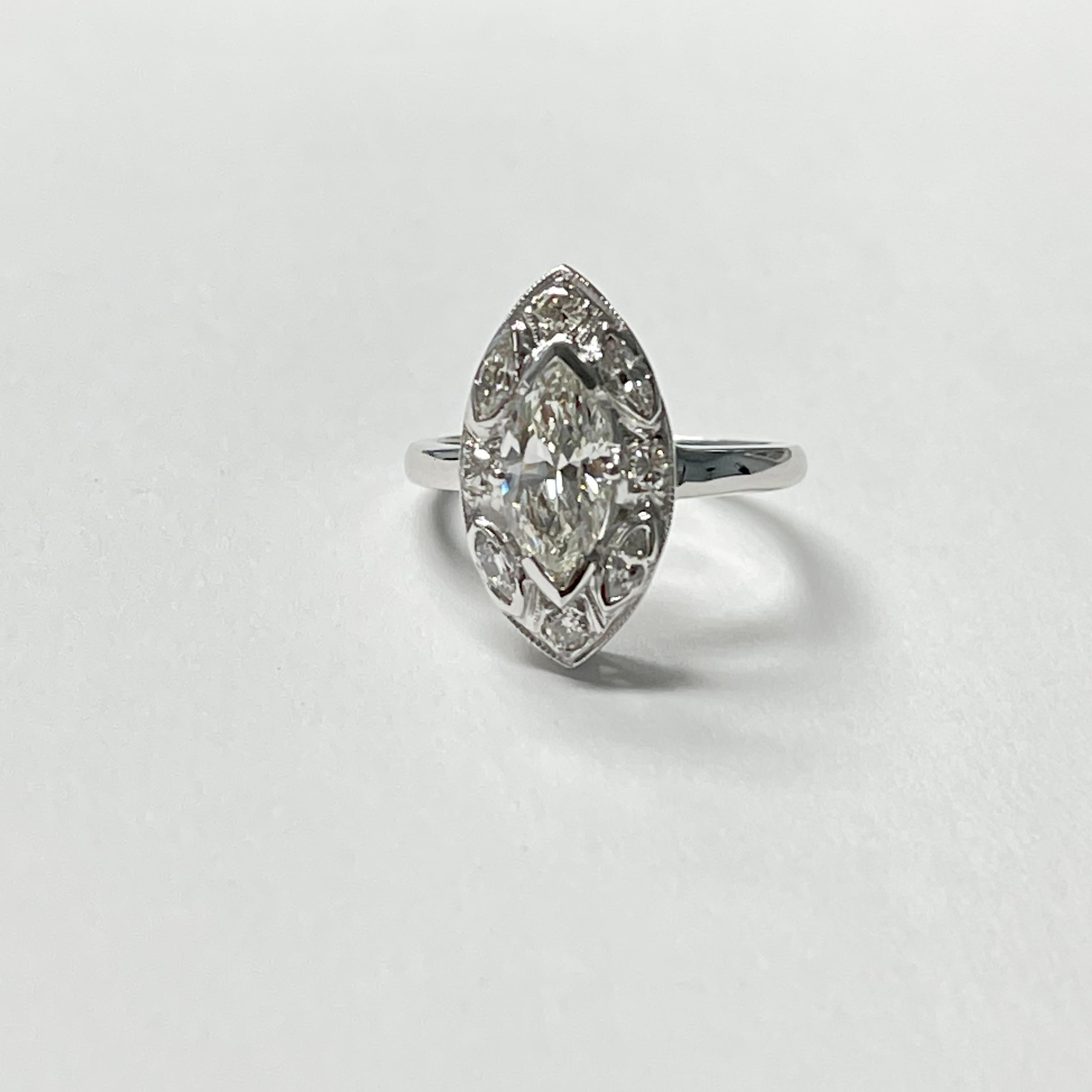 GIA Certified 1.02 Carat Marquise Diamond Engagement Ring Handcrafted In 18K White Gold. 
Diamond weight : 1.02 carat I color and VS1 clarity 
Small diamond weight : 0.60 carat 
Metal : 18k white gold 
Measurements for 1.02 carat marquise diamond :